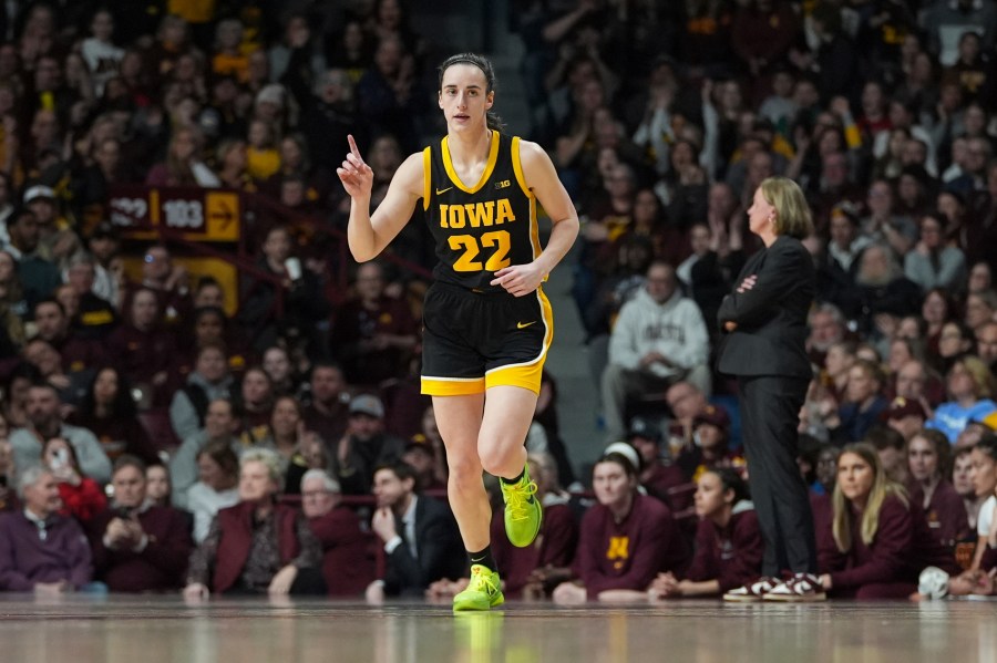 Iowa guard Caitlin Clark (22) points after an Iowa basket scored during the first half of an NCAA college basketball game against Minnesota, Wednesday, Feb. 28, 2024, in Minneapolis. (AP Photo/Abbie Parr)