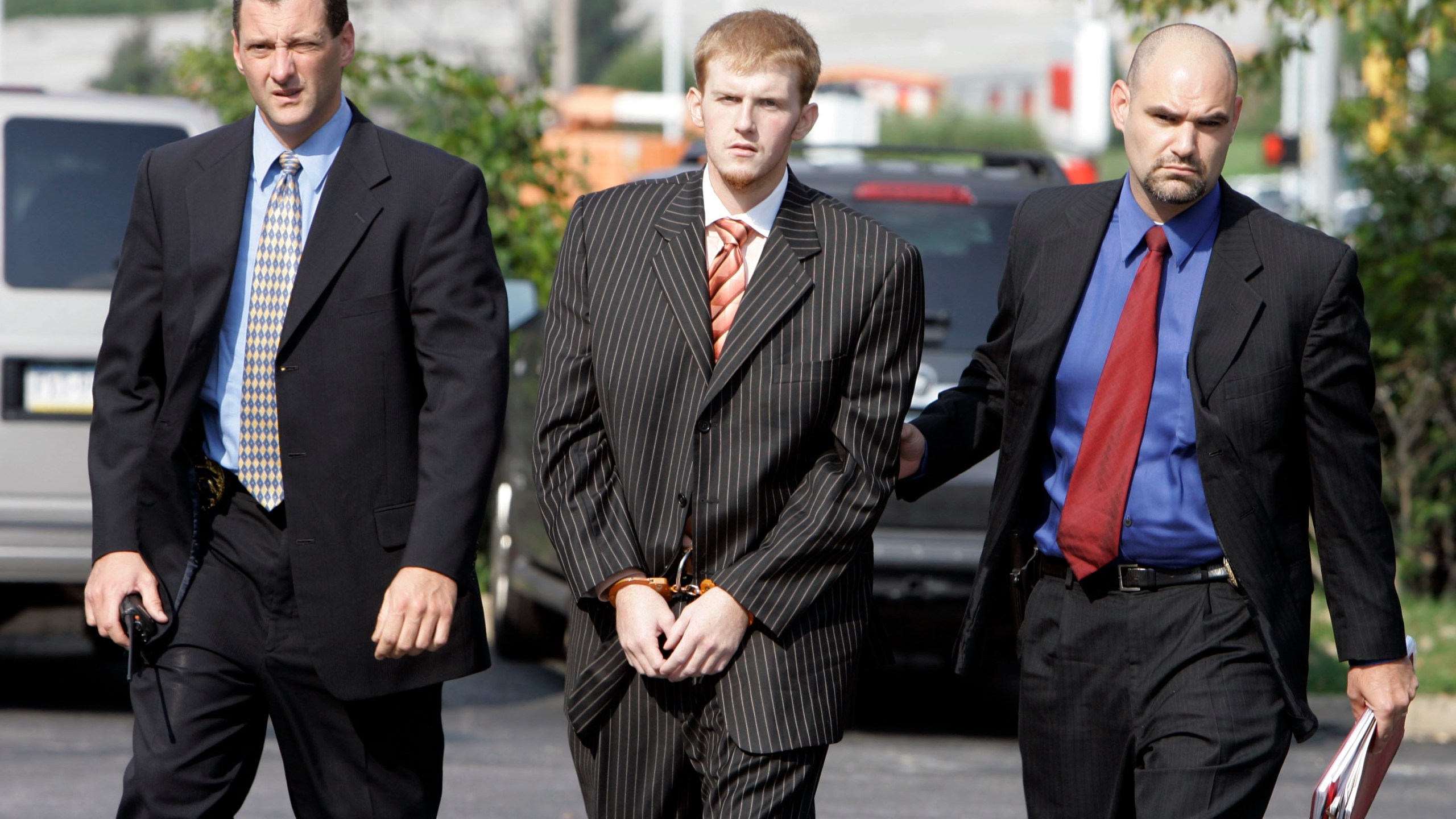 FILE - In this Aug. 29, 2007, file photo, former Kansas City Chiefs assistant coach Britt Reid is escorted into the Montgomery County district court house in Conshohocken, Pa. Missouri Gov. Mike Parson on Friday, March 1, 2024, shortened the prison sentence of Reid for a drunken driving crash that seriously injured a 5-year-old girl. (AP Photo/Matt Rourke, File)