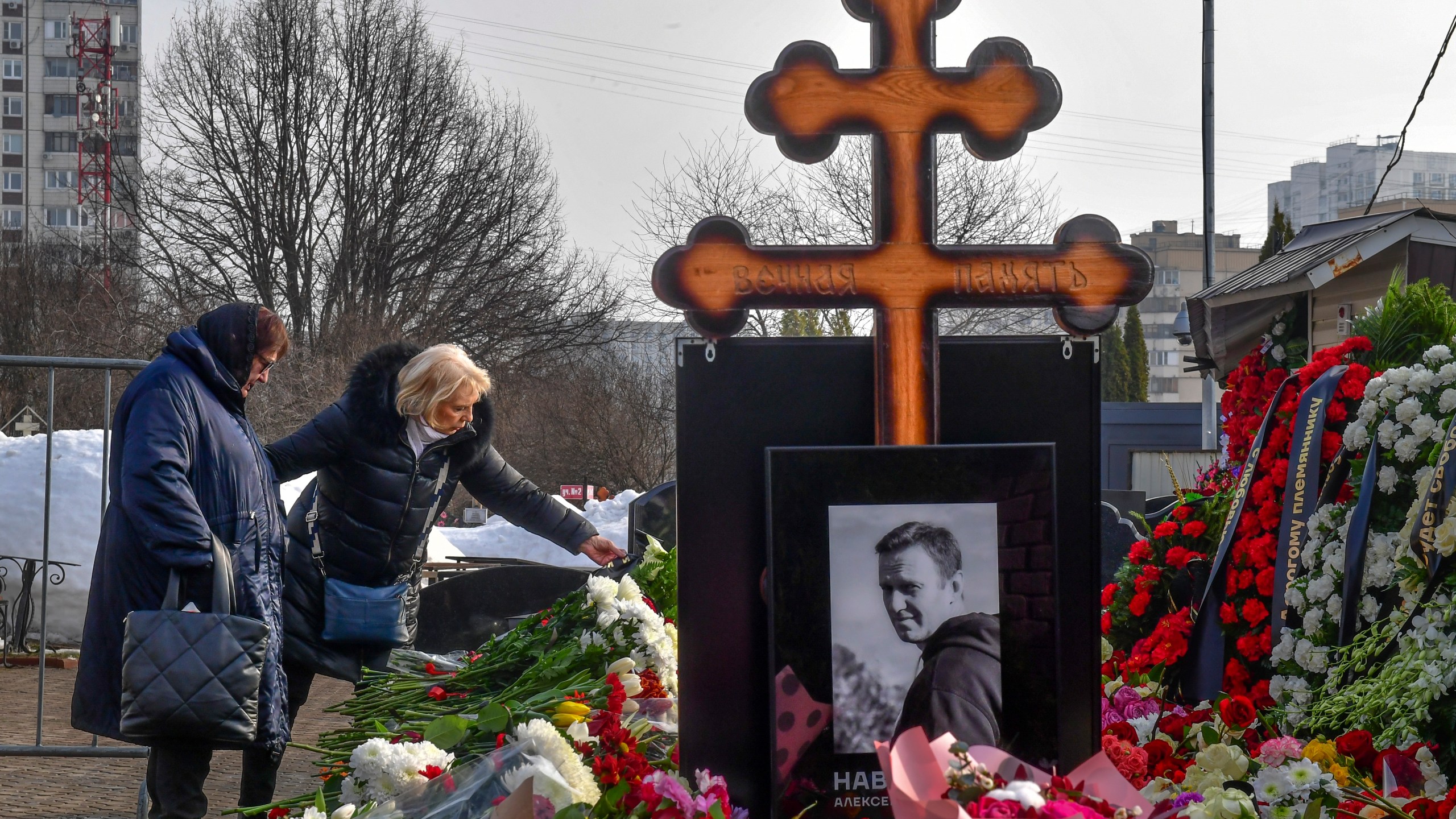 Russian opposition leader Alexei Navalny's mother, Lyudmila Navalnaya, left, and his mother-in-law, no name available, visit the grave of Alexei Navalny after his yesterday funeral at the Borisovskoye Cemetery, in Moscow, Russia, on Saturday, March 2, 2024. Navalny, who was President Vladimir Putin's fiercest foe, was buried after a funeral that drew thousands of mourners amid a heavy police presence. (AP Photo)