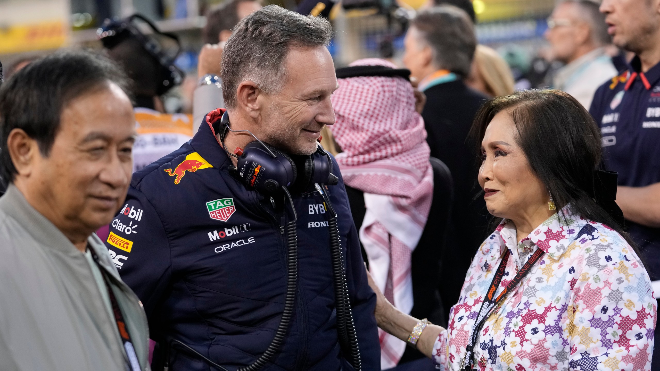 Red Bull co-owner Chalerm Yoovidhya, left, and his wife Daranee, right, speak with Red Bull team principal Christian Horner during the Formula One Bahrain Grand Prix at the Bahrain International Circuit in Sakhir, Bahrain, Saturday, March 2, 2024. (AP Photo/Darko Bandic)