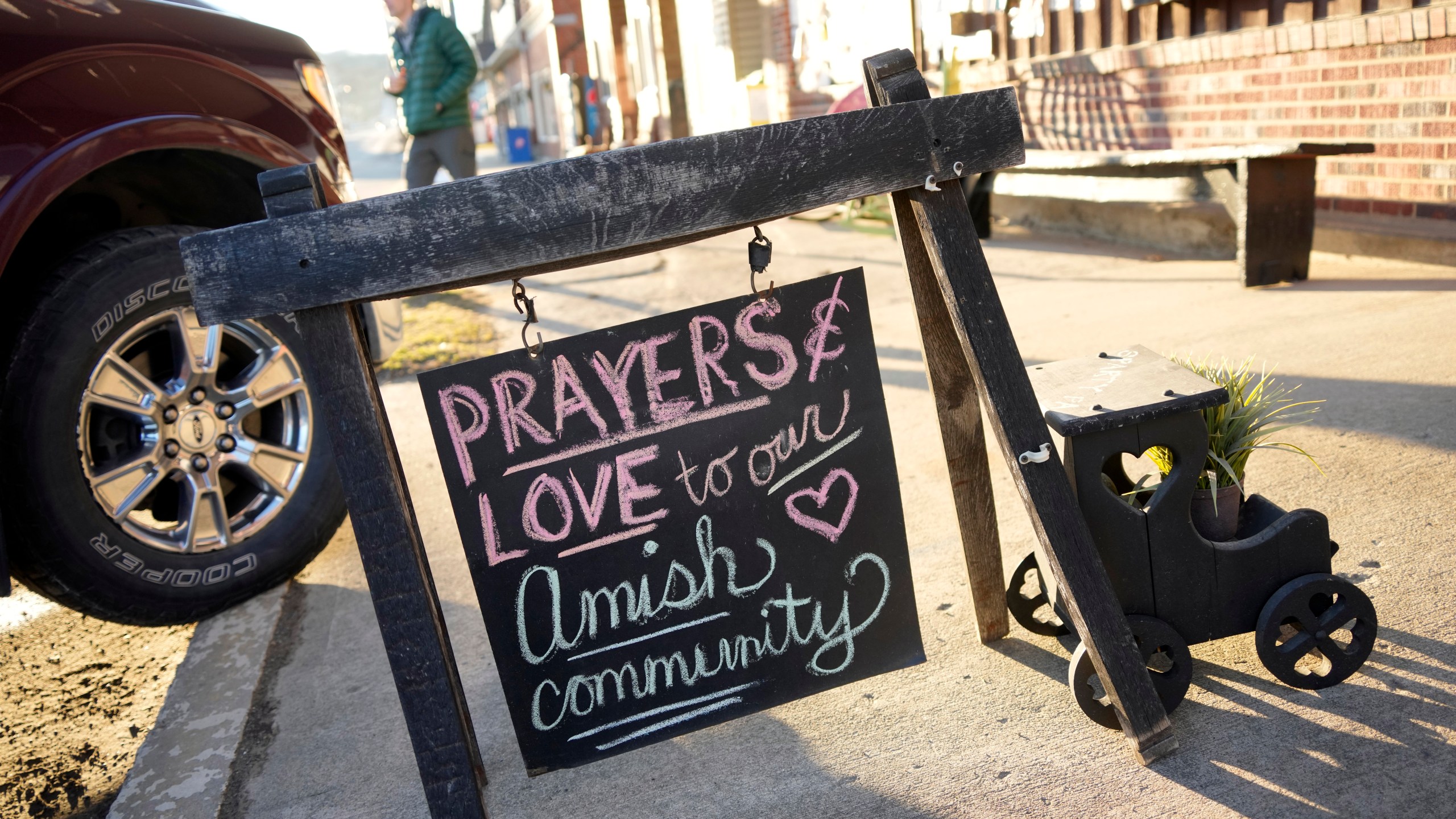FILE - A sign on the sidewalk outside an antique store in Spartansburg, Pa., on Thursday, Feb. 29, 2024. Shawn C. Cranston was arrested Saturday, March 2, and charged with the slaying of a pregnant Amish woman whose body was found last week. (AP Photo/Gene J. Puskar)
