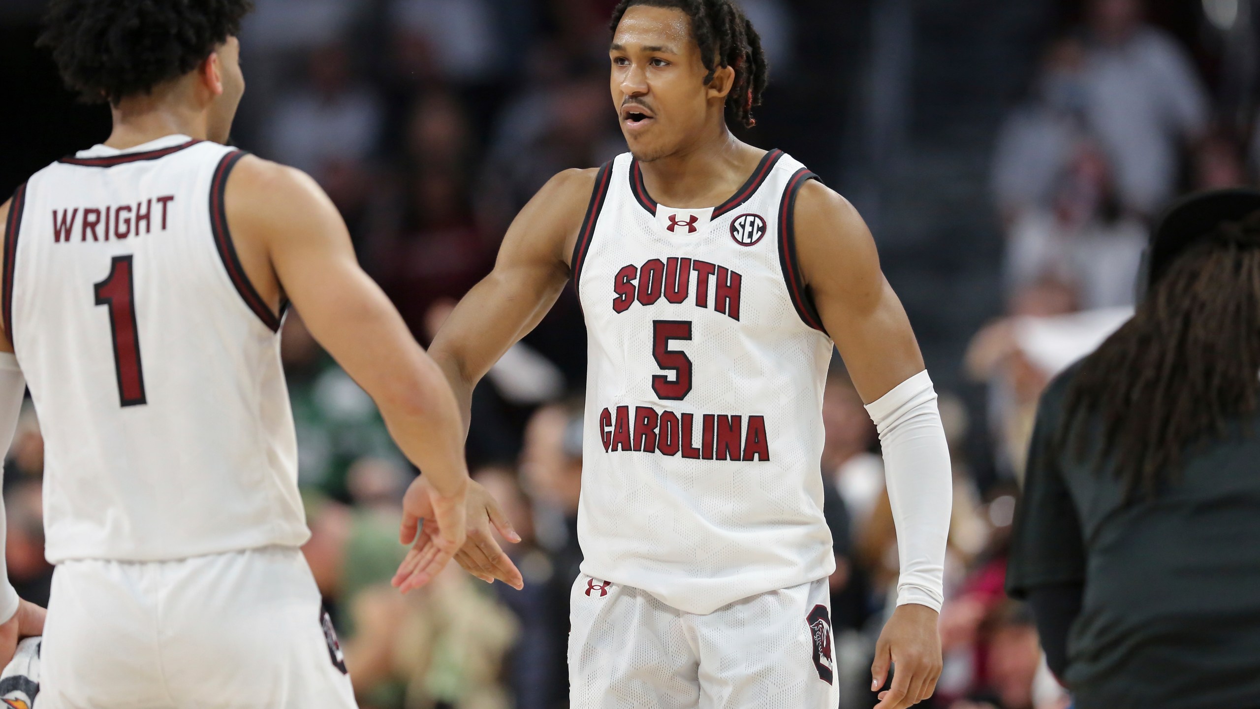 South Carolina guard Meechie Johnson (5) celebrates with guard Jacobi Wright (1) during the second half of an NCAA college basketball game against Florida Saturday, March 2, 2024, in Columbia, S.C. (AP Photo/Artie Walker Jr.)