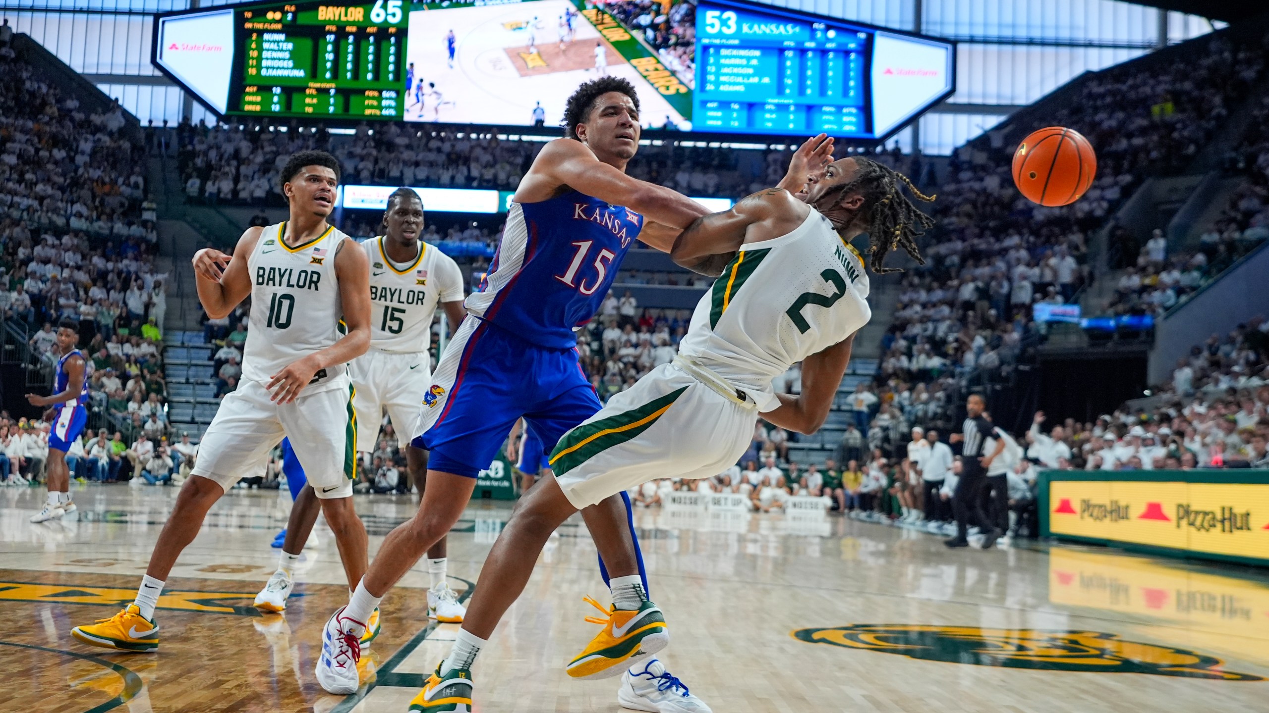 Kansas's Kevin McCullar Jr. (15) and Baylor's Jayden Nunn (2) compete for a rebound during the second half of an NCAA college basketball game, Saturday, March 2, 2024, in Waco, Texas. Baylor's RayJ Dennis (10) and Josh Ojianwuna (15) look on. Baylor won 82-74. (AP Photo/Julio Cortez)