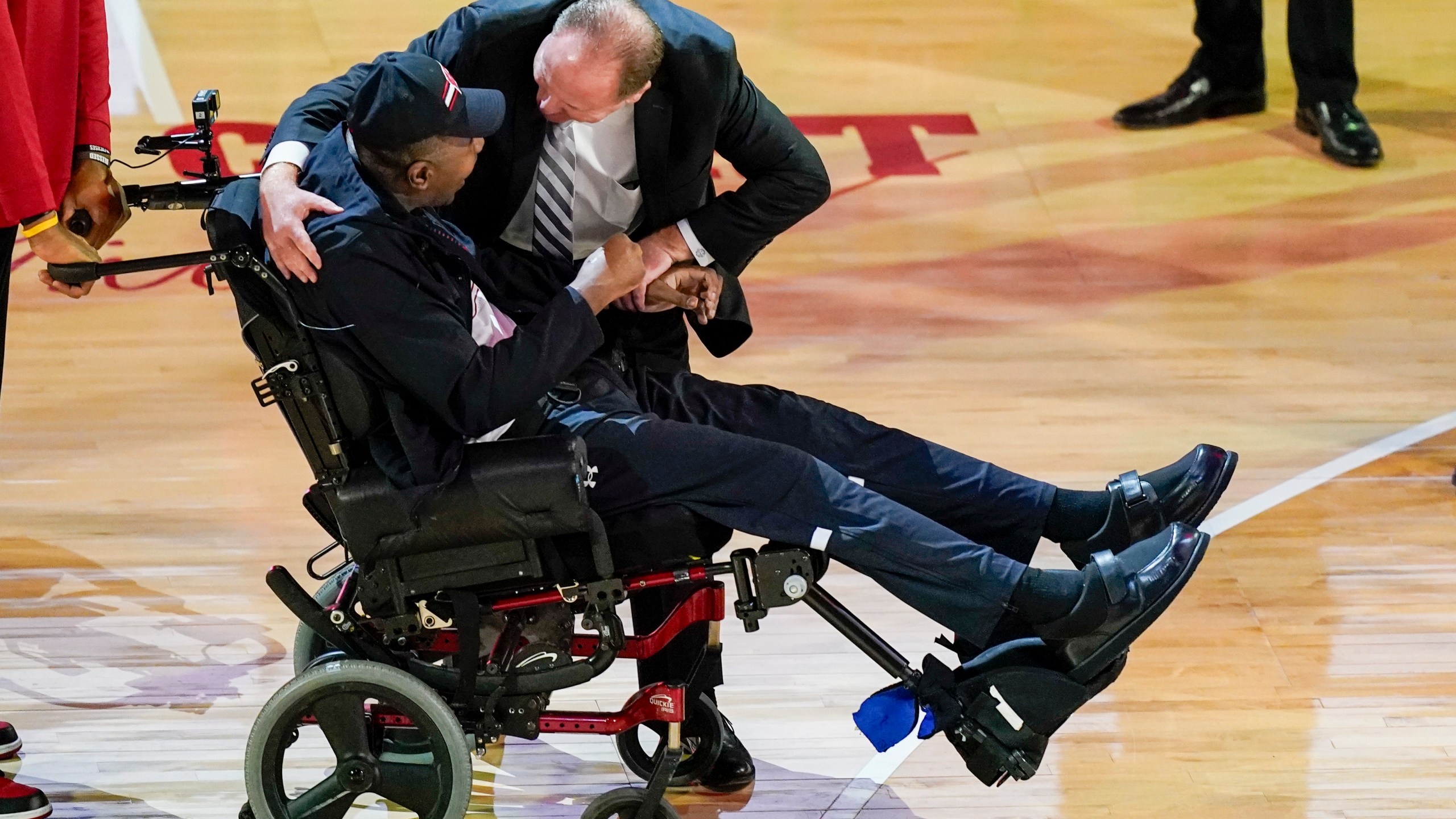 Former Wisconsin player and assistant coach Howard Moore is greeted by Wisconsin coach Greg Gard Saturday, March 2, 2024, in Madison, Wis., in in his first public appearance at the Kohl Center since a 2019 car wreck killed his wife and daughter and left him with serious injuries. (AP Photo/Andy Manis)