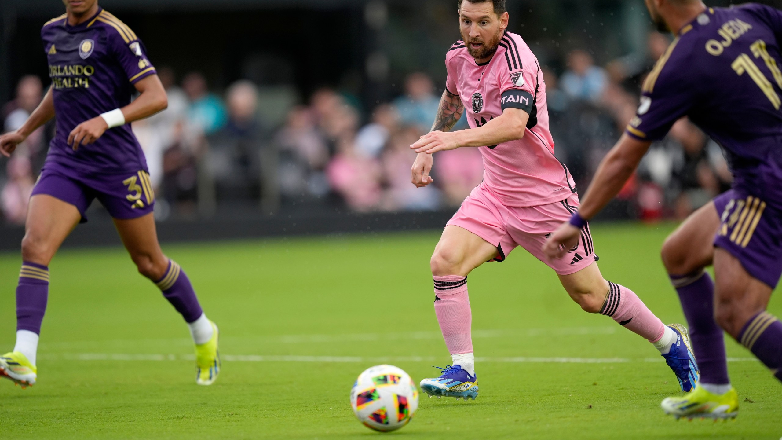 Inter Miami forward Lionel Messi (10) dribbles the ball under pressure from Orlando City midfielder Martín Ojeda (11) and Orlando City defender Rafael Santos (3) during the first half of an MLS soccer match, Saturday, March 2, 2024, in Fort Lauderdale, Fla. (AP Photo/Rebecca Blackwell)