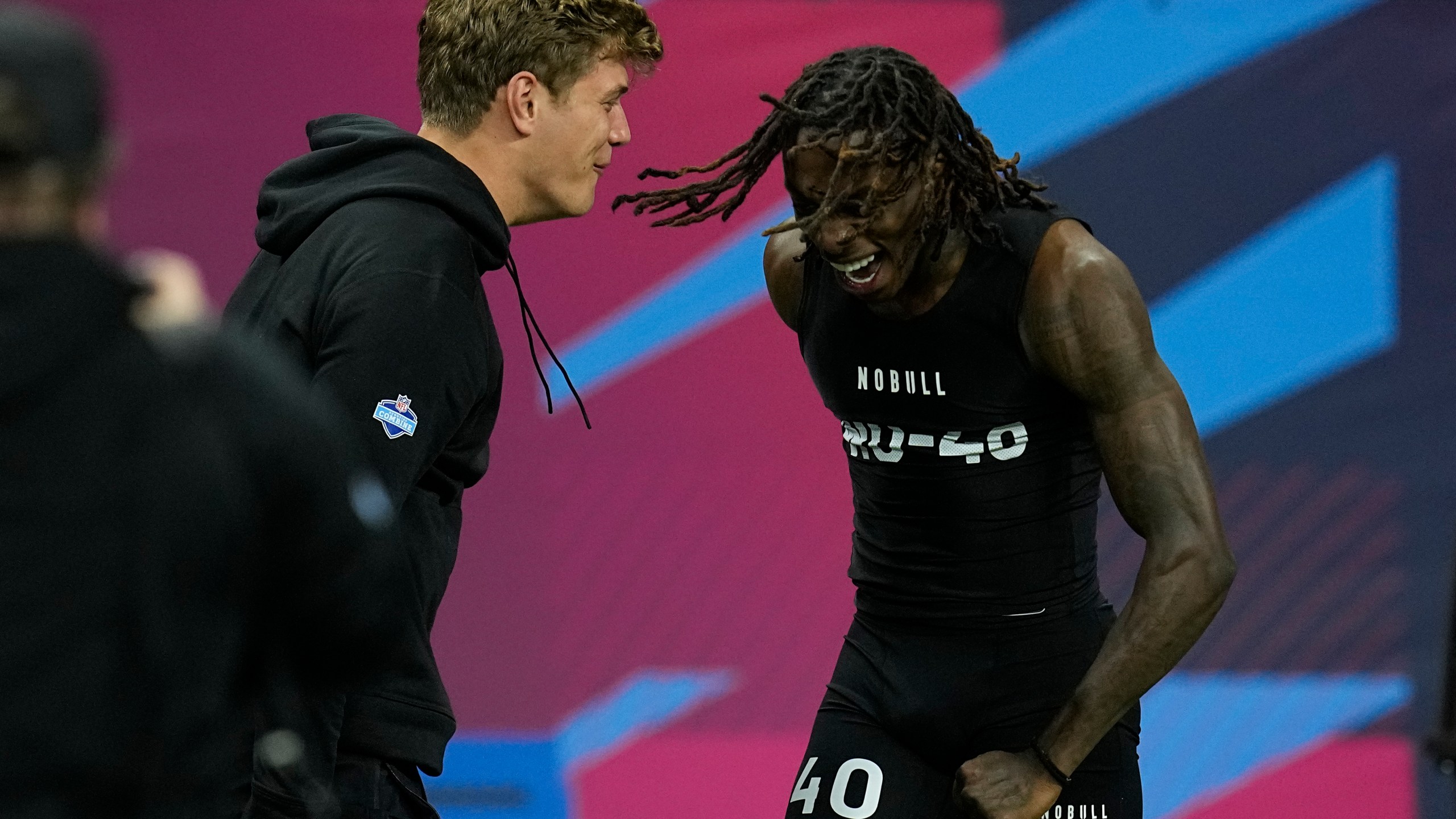 Texas wide receiver Xavier Worthy, right, celebrates with Iowa defensive back Cooper Dejean after running the 40-yard dash at the NFL football scouting combine, Saturday, March 2, 2024, in Indianapolis. (AP Photo/Darron Cummings)