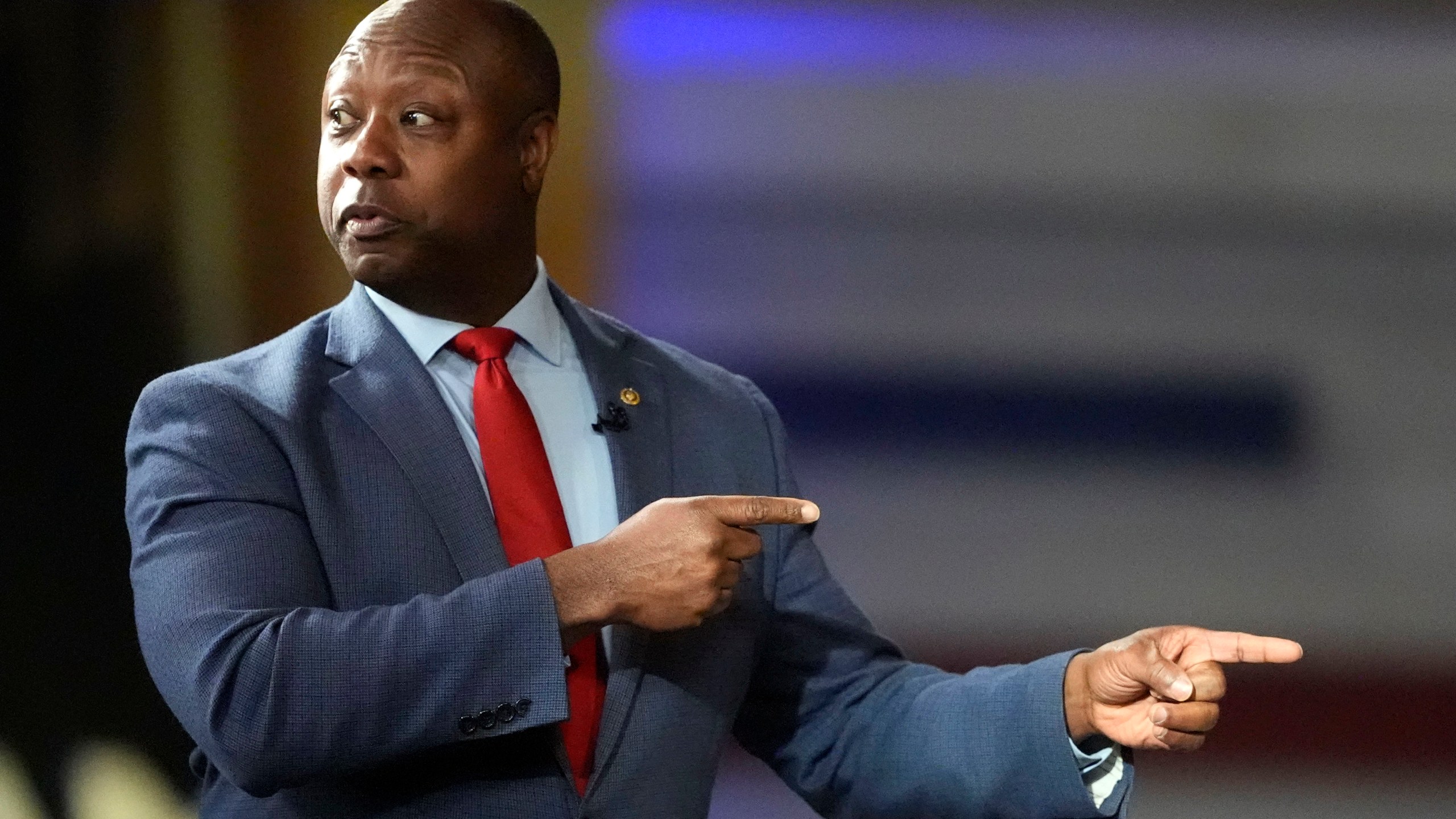 Sen. Tim Scott, R-S.C., points to Republican presidential candidate former President Donald Trump during a Fox News Channel town hall Tuesday, Feb. 20, 2024, in Greenville, S.C. (AP Photo/Chris Carlson)