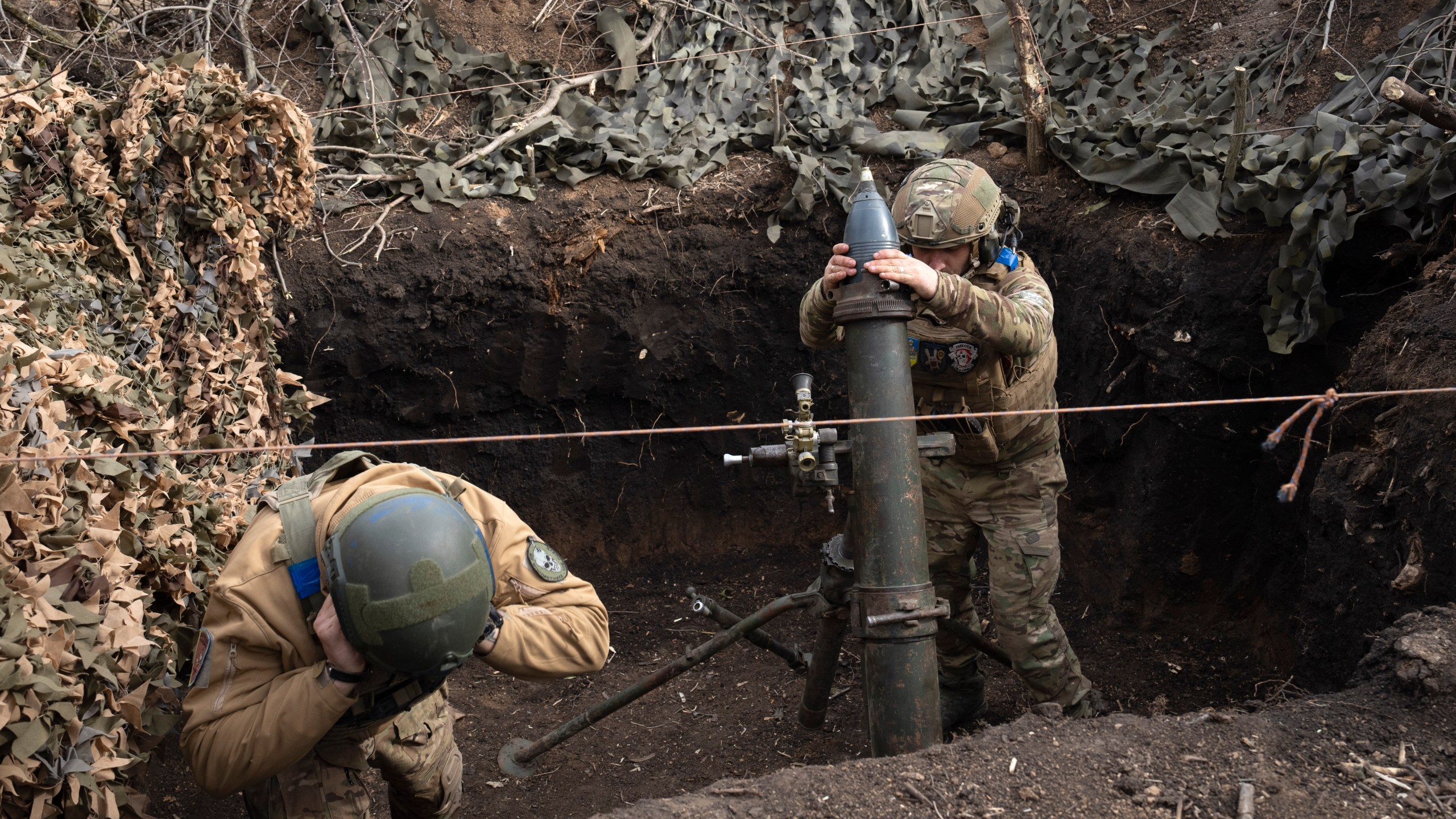 Ukrainian servicemen of the 28th Separate Mechanised Brigade fires a 122mm mortar towards Russian positions at the front line, near Bakhmut, Donetsk region, Ukraine, Sunday, March 3, 2024. (AP Photo/Efrem Lukatsky)