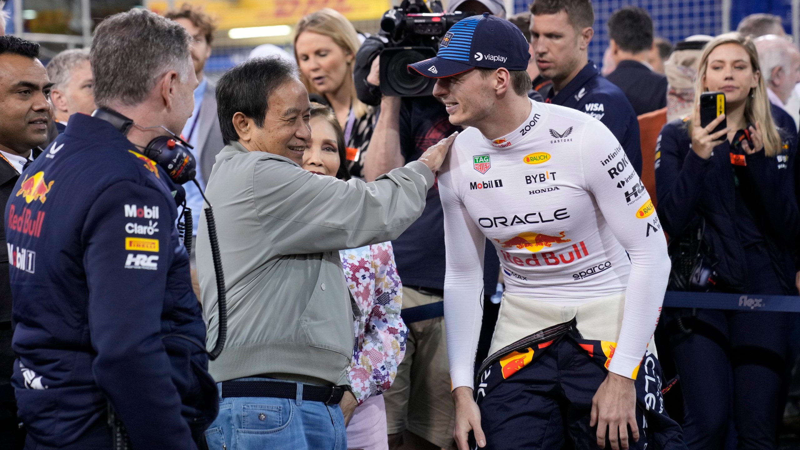 Red Bull team principal Christian Horner, left, Red Bull co-owner Chalerm Yoovidhya and his wife Daranee, center, speak with Red Bull driver Max Verstappen of the Netherlands during the Formula One Bahrain Grand Prix at the Bahrain International Circuit in Sakhir, Bahrain, Saturday, March 2, 2024. (AP Photo/Darko Bandic)