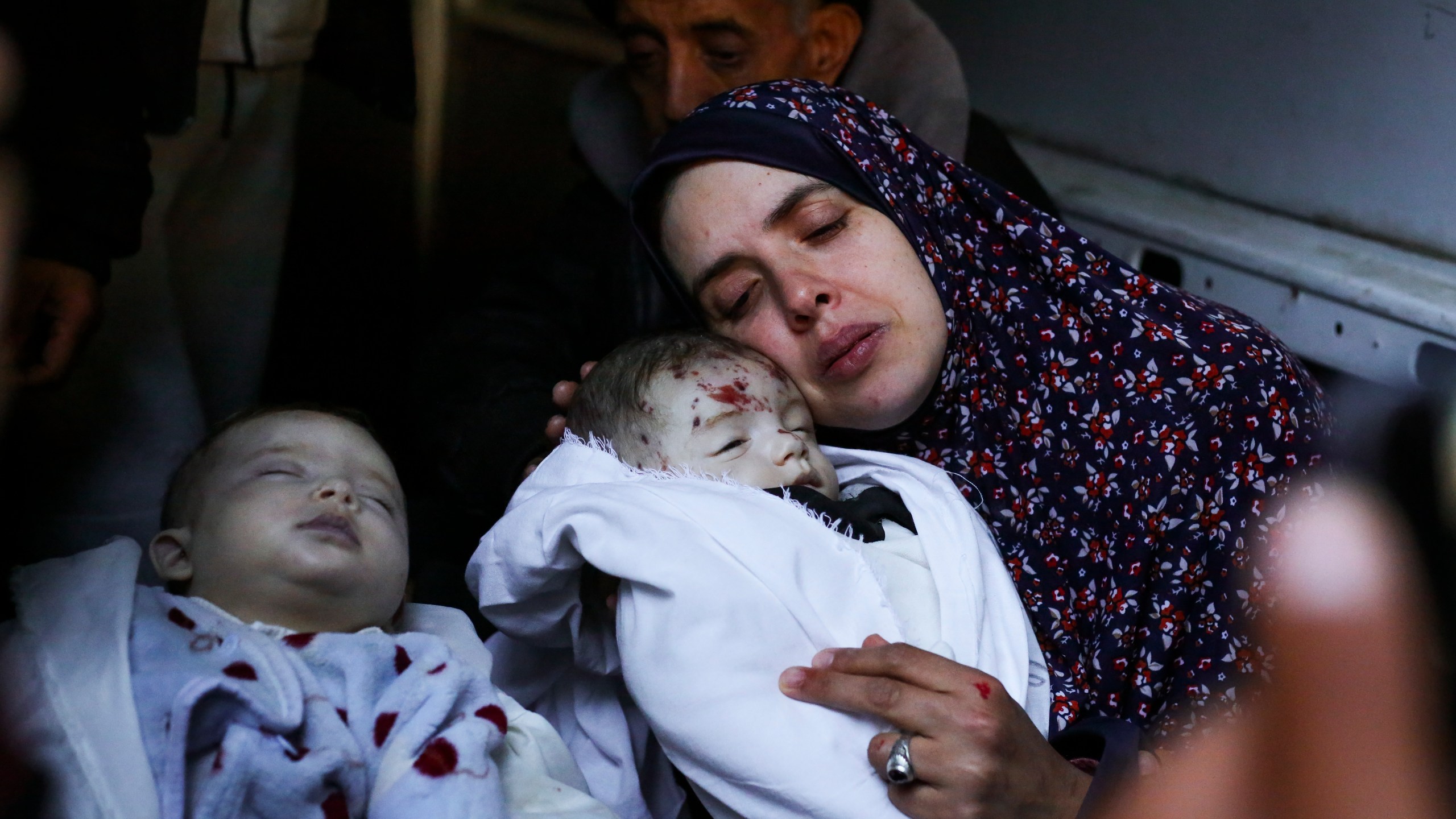 Rania Abu Anza cradles her twins, who were killed in an Israel strike on a house in Rafah, in the southern Gaza Strip, Sunday, March 3, 2024. Abu Anza and her husband, who was killed in the same strike, spent 10 years trying to get pregnant. (AP Photo/Hatem Ali)