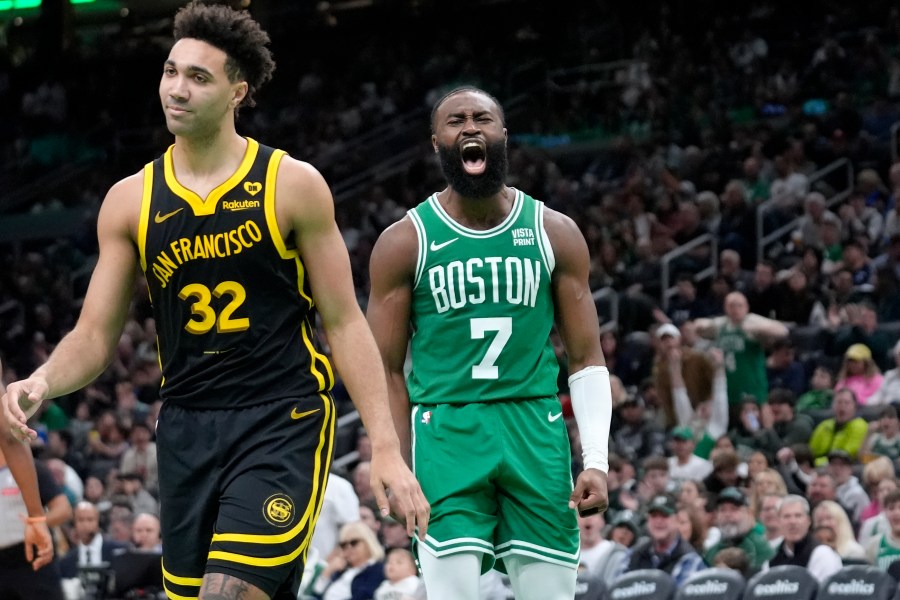 Boston Celtics guard Jaylen Brown (7) celebrates near Golden State Warriors forward Trayce Jackson-Davis (32) after scoring in the second half of an NBA basketball game, Sunday, March. 3, 2024, in Boston. (AP Photo/Steven Senne)