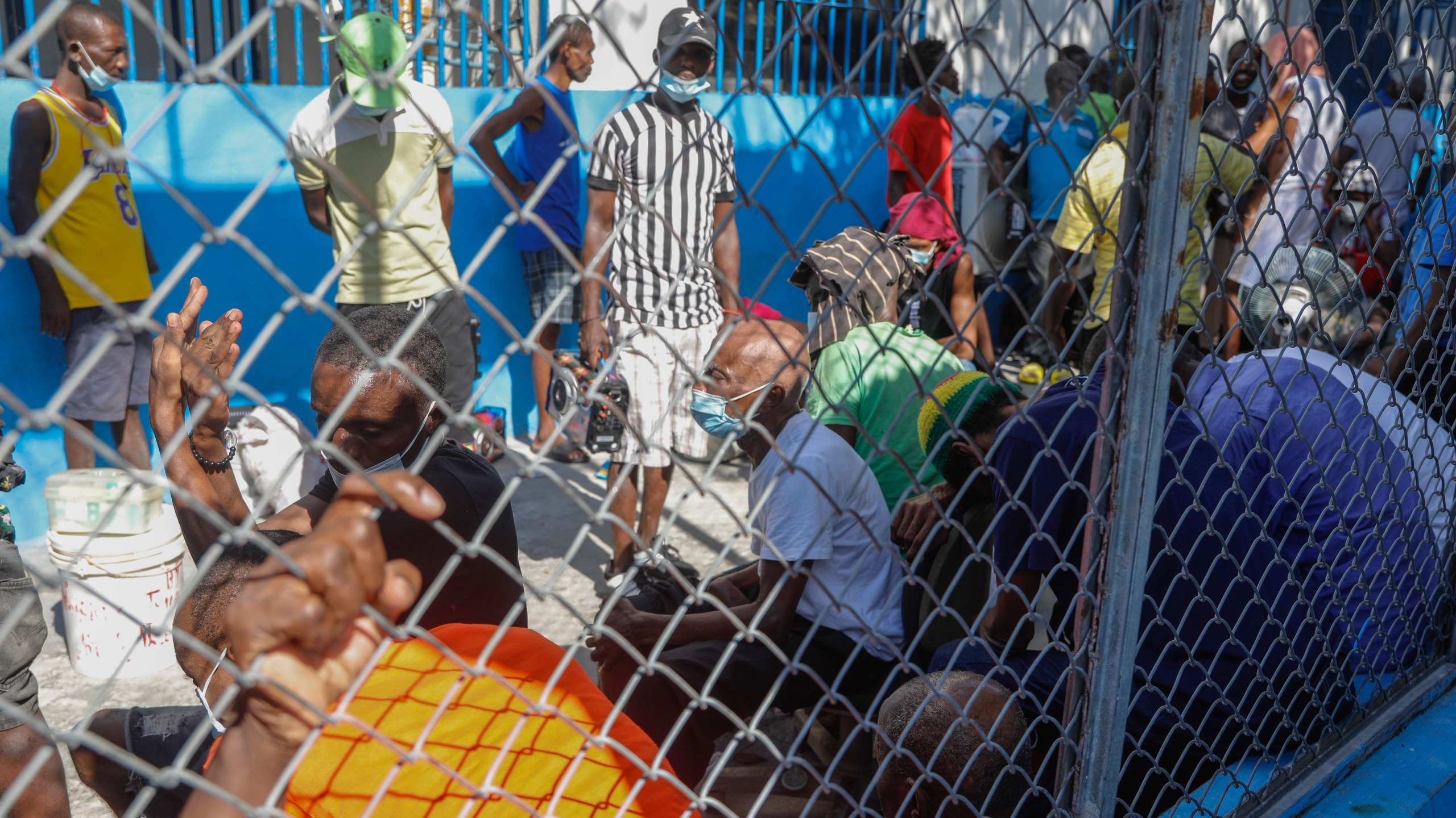 Inmates gather inside the National Penitentiary in downtown Port-au-Prince, Haiti, Sunday, March 3, 2024. Hundreds of inmates fled Haiti's main prison after armed gangs stormed the facility overnight. (AP Photo/Odelyn Joseph)
