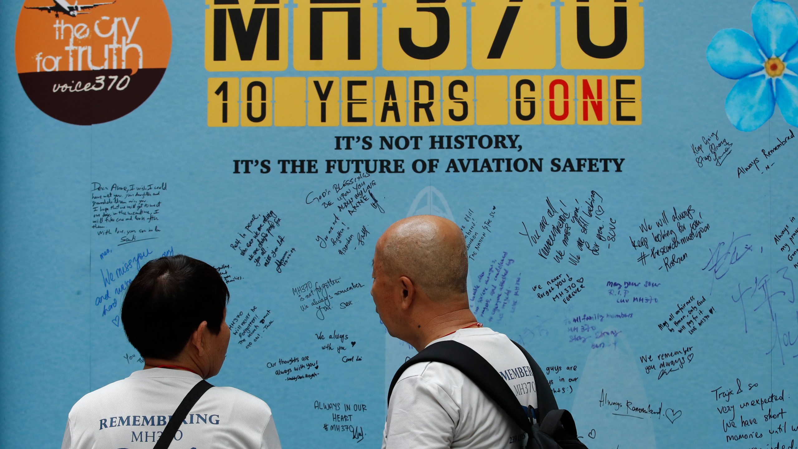 Family members of passengers on board from China of the missing Malaysia Airlines Flight 370 look at the messages board during the tenth annual remembrance event at a shopping mall, in Subang Jaya, on the outskirts of Kuala Lumpur, Malaysia, Sunday, March 3, 2024. Ten years ago, a Malaysia Airlines Flight 370, had disappeared March 8, 2014 while en route from Kuala Lumpur to Beijing with 239 people on board. (AP Photo/FL Wong)