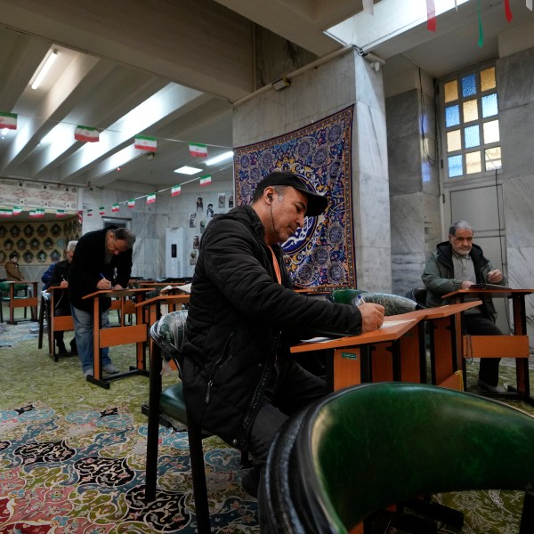 Voters fill out their ballots during the parliamentary and Assembly of Experts elections at a polling station in Tehran, Iran, Friday, March 1, 2024. Iran on Friday held the country's first election since the mass 2022 protests over mandatory hijab laws after the death in police custody of Mahsa Amini, with questions looming over just how many people will turn out at the polls. (AP Photo/Vahid Salemi)