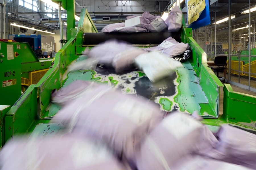 Parcels slide down a ramp after being scanned at the U.S. Customs and Border Protection overseas mail inspection facility at Chicago's O'Hare International Airport Feb. 23, 2024, in Chicago. The explosive growth of cross-border e-commerce involving major China-backed players such as Shein and Temu has caught the attention of the U.S. lawmakers amid a bitter U.S.-China trade war and cast a spotlight on a tax rule that critics say has allowed hundreds of millions of China-originated packages to enter the U.S. market each year without duty and without reliable information for lawfulness. (AP Photo/Charles Rex Arbogast)