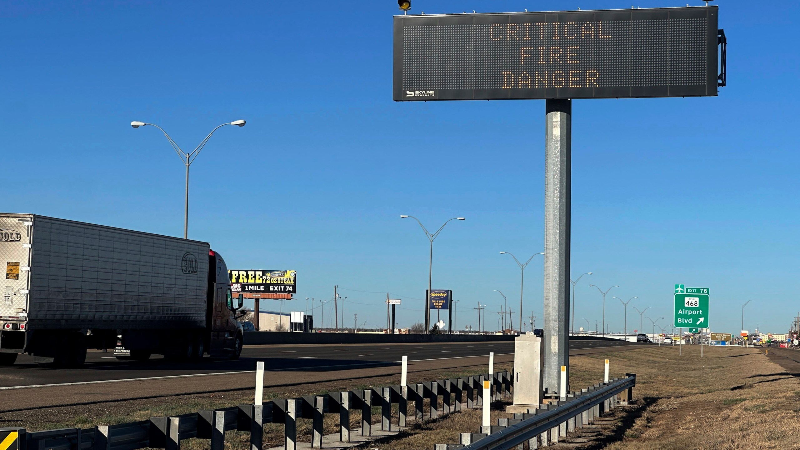 A truck passes a warning sign about the Smokehouse Creek Fire on a highway in Amarillo, Texas on Saturday, March 2, 2024. Firefighters battling the largest wildfire in Texas history face increasingly difficult weather (AP Photo/Ty O'Neil)