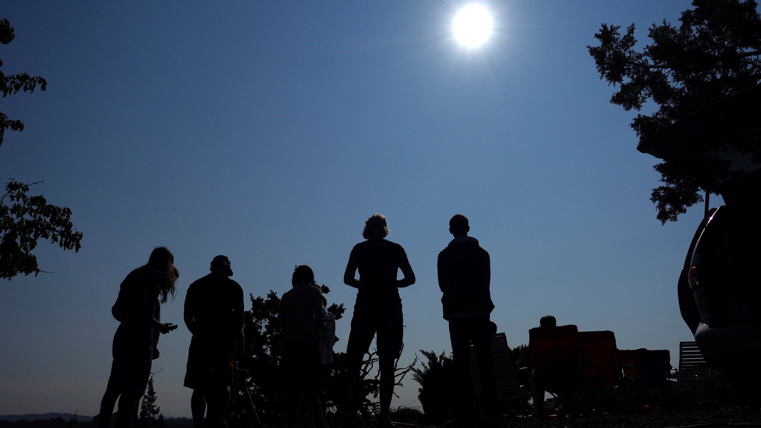 FILE - People gather near Redmond, Ore., to view the sun as it nears a total eclipse by the moon, Monday, Aug. 21, 2017. The April 8, 2024 total solar eclipse in North America first hits land at Mexico’s Pacific coast, cuts diagonally across the U.S. from Texas to Maine and exits in eastern Canada. (AP Photo/Ted S. Warren, File)