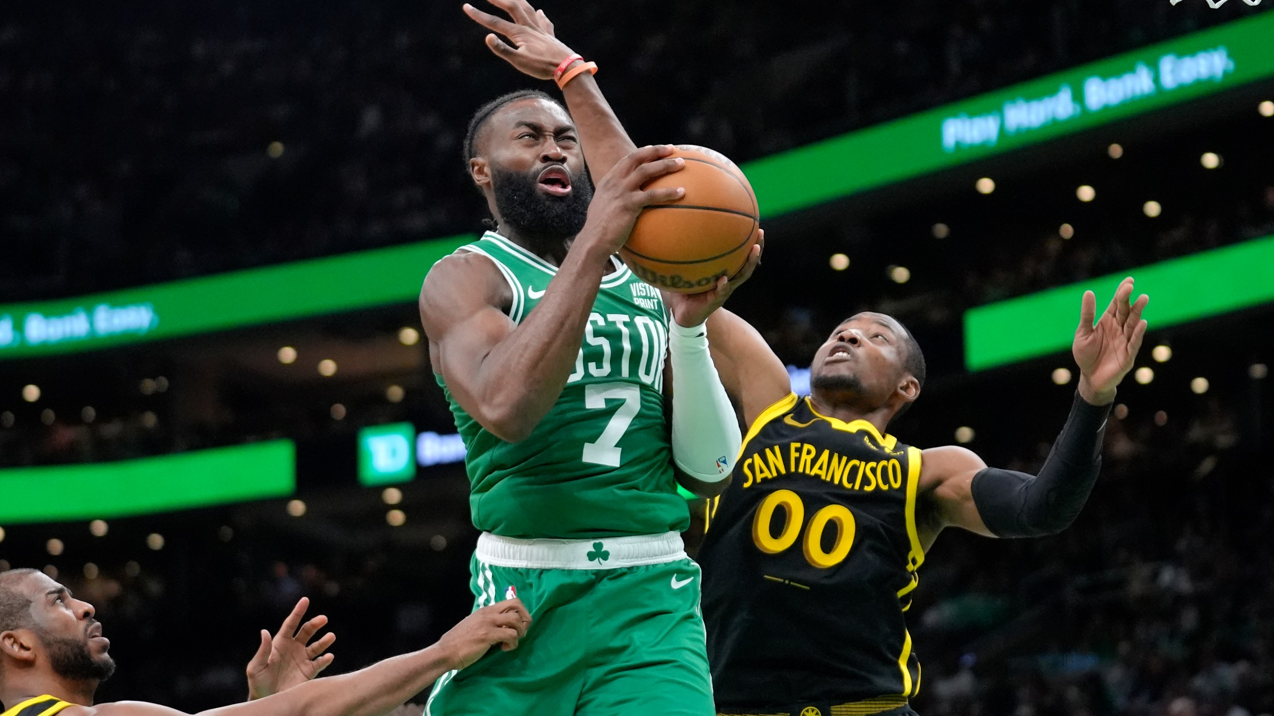 Boston Celtics guard Jaylen Brown (7) drives to the basket as Golden State Warriors forward Jonathan Kuminga (00) defends in the second half of an NBA basketball game, Sunday, March. 3, 2024, in Boston. (AP Photo/Steven Senne)