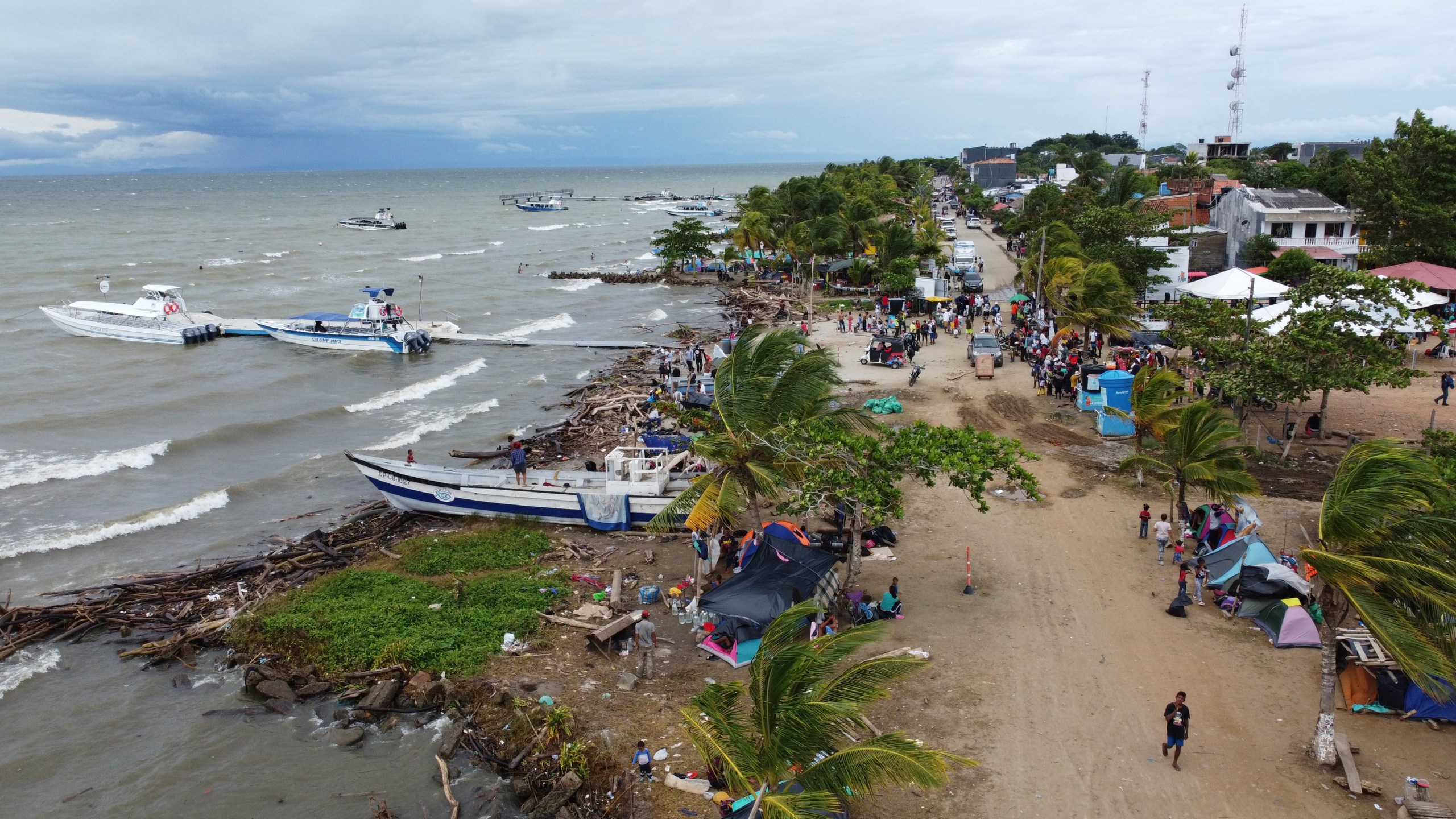 FILE - Migrants gather in Necocli, Colombia, a stopping point for migrants taking boats to Acandi which leads to the Darien Gap, Oct. 13, 2022. The flow of thousands of migrants daily through the migratory highway, the Darien Gap, has been cut off following the Feb. 26, 2024 capture in Necoclí of some boat captains who had been ferrying the migrants to the starting point of their jungle trek. (AP Photo/Fernando Vergara, File)