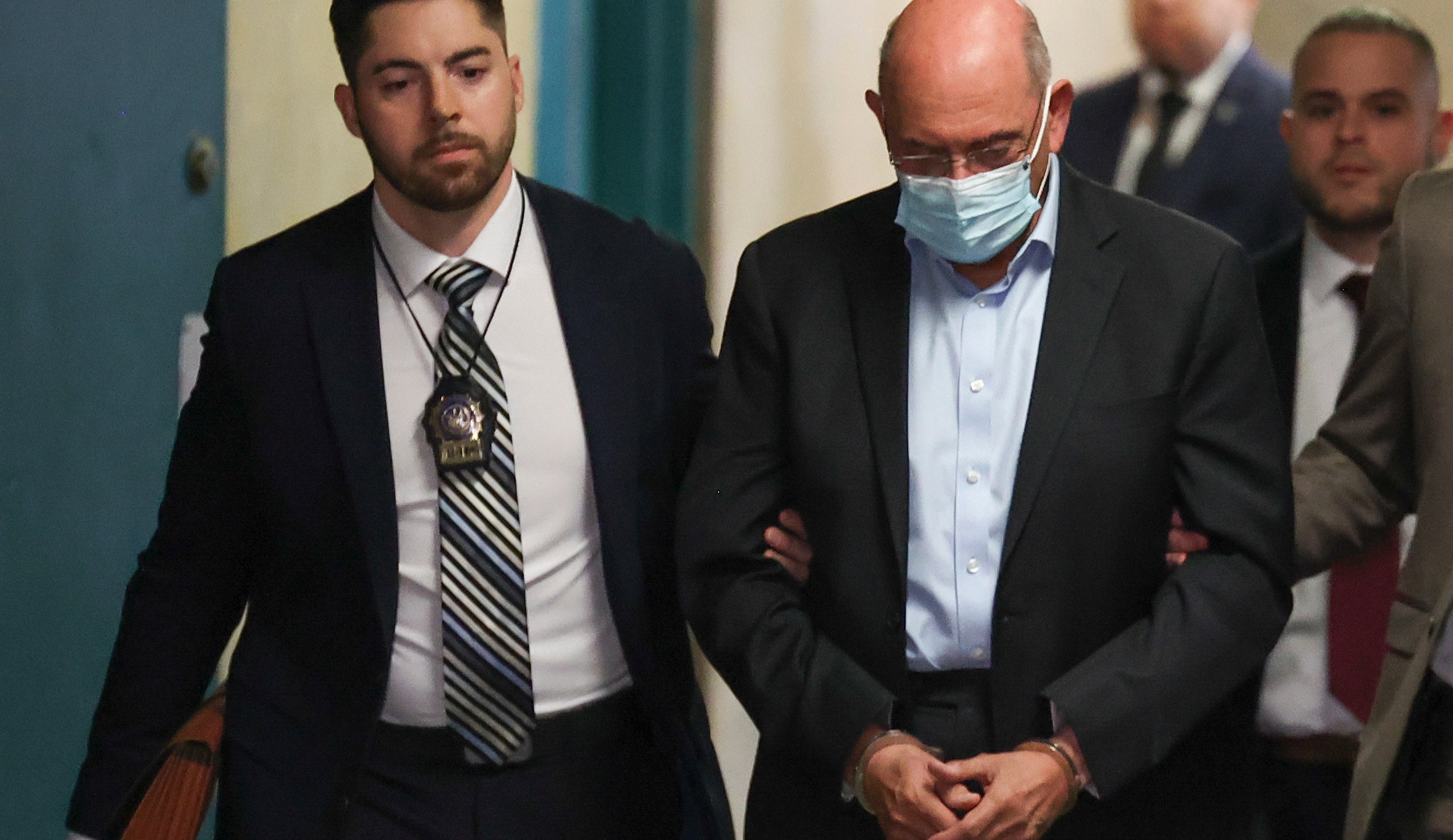 Allen Weisselberg, right, is escorted to Manhattan criminal court, Monday, March 4, 2024, in New York. Weisselberg, the former chief financial officer of the Trump Organization, surrendered to the Manhattan district attorney Monday morning for arraignment on new criminal charges, the prosecutor's office said. (AP Photo/Yuki Iwamura)