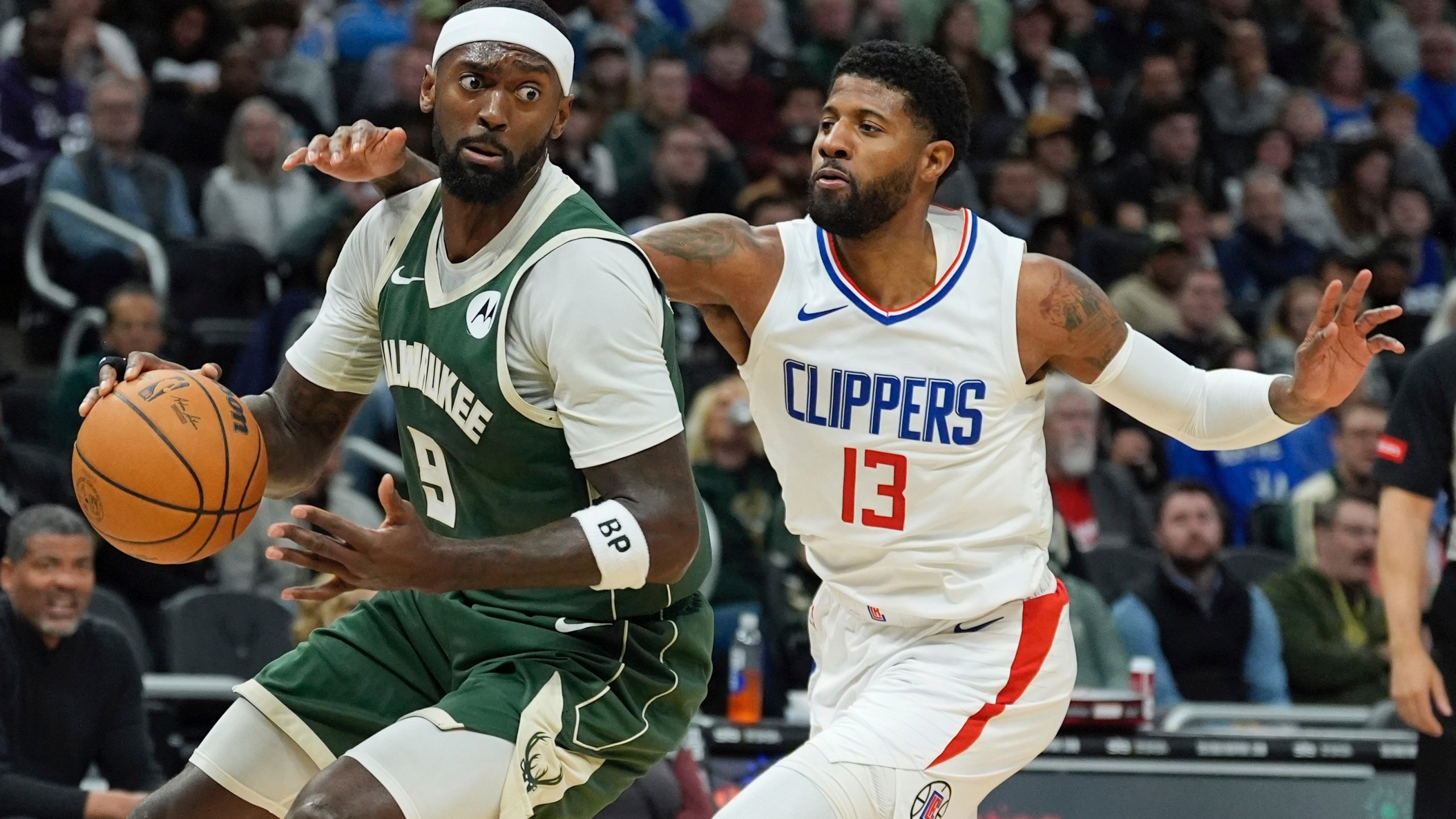 Milwaukee Bucks' Bobby Portis looks to get past LA Clippers' Paul George during the first half of an NBA basketball game Monday, March 4, 2024, in Milwaukee. (AP Photo/Morry Gash)