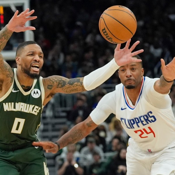 LA Clippers' Norman Powell knocks the ball from Milwaukee Bucks' Damian Lillard during the first half of an NBA basketball game Monday, March 4, 2024, in Milwaukee. (AP Photo/Morry Gash)