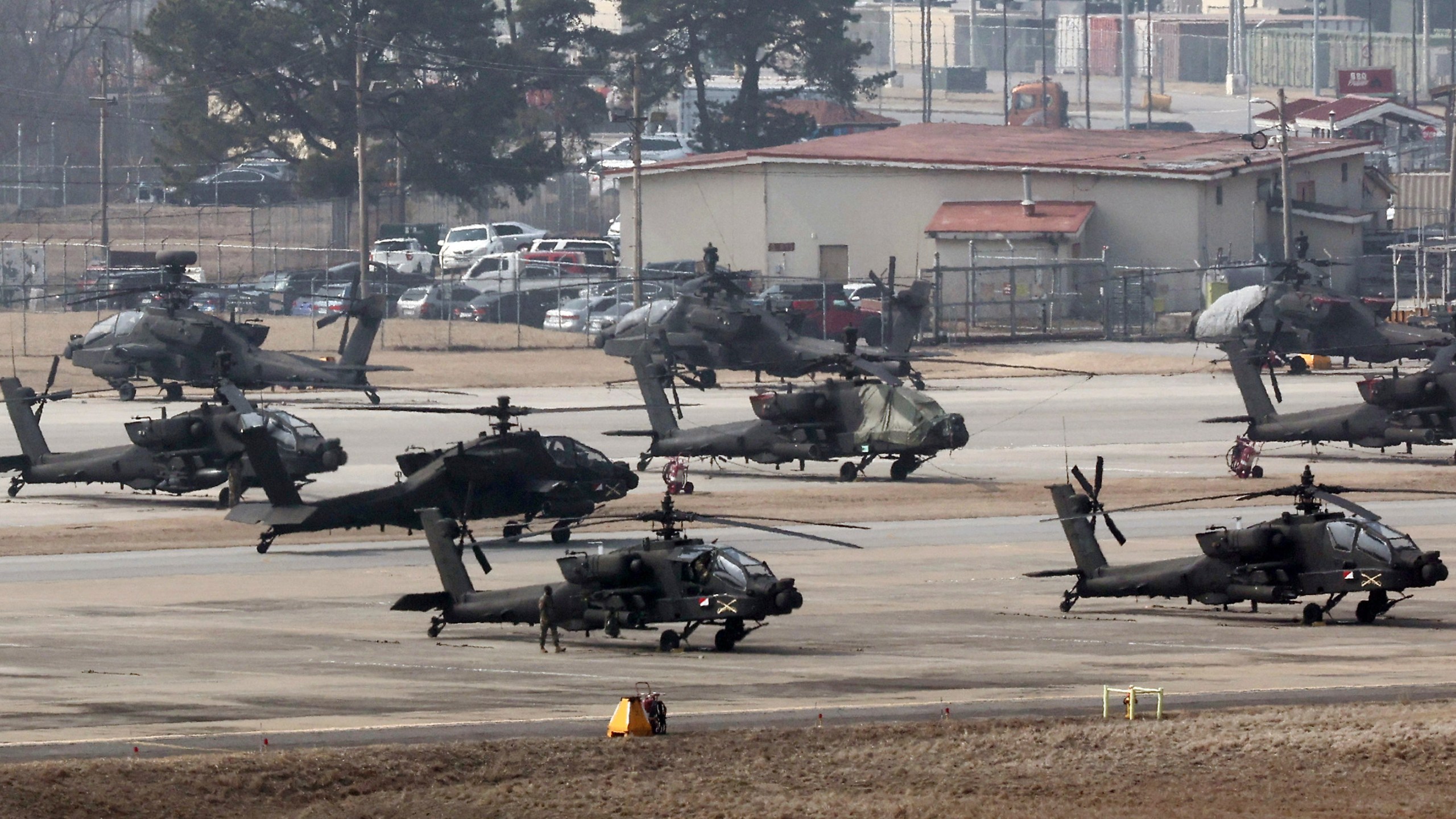 U.S. Army Apache helicopters take off at Camp Humphreys in Pyeongtaek, South Korea, Monday, March 4, 2024. North Korea called the ongoing South Korean-U.S. military drills a plot to invade the country, as it threatened Tuesday to take unspecified "responsible" military steps in response. (Kwon June-woo/Yonhap via AP)