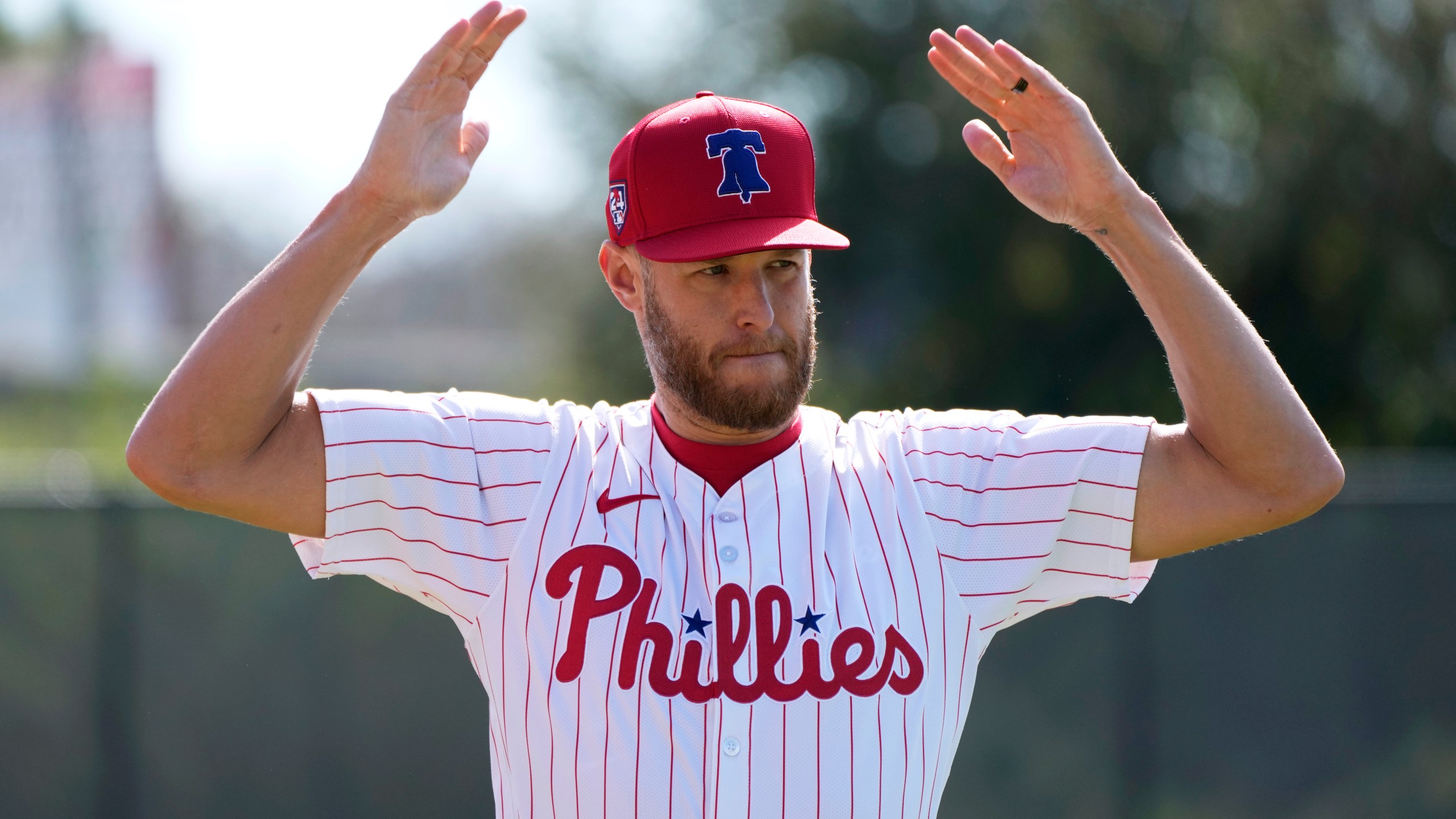 Philadelphia Phillies pitcher Zack Wheeler stretches during a baseball spring training workout Wednesday, Feb. 14, 2024, in Clearwater, Fla. (AP Photo/Charlie Neibergall)