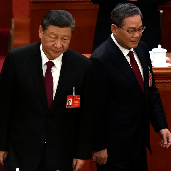 Chinese President Xi Jinping, left, and Chinese Premier Li Qiang arrive for the opening session of the National People's Congress (NPC) in Beijing, China, Tuesday, March 5, 2024. (AP Photo/Ng Han Guan)