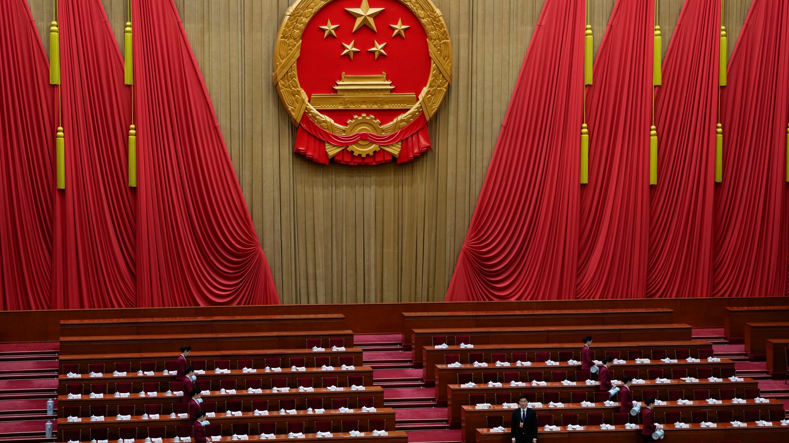 A member of security looks on before the opening session of the The National People's Congress (NPC) at the Great Hall of the People in Beijing, China, Tuesday, March 5, 2024. (AP Photo/Ng Han Guan)