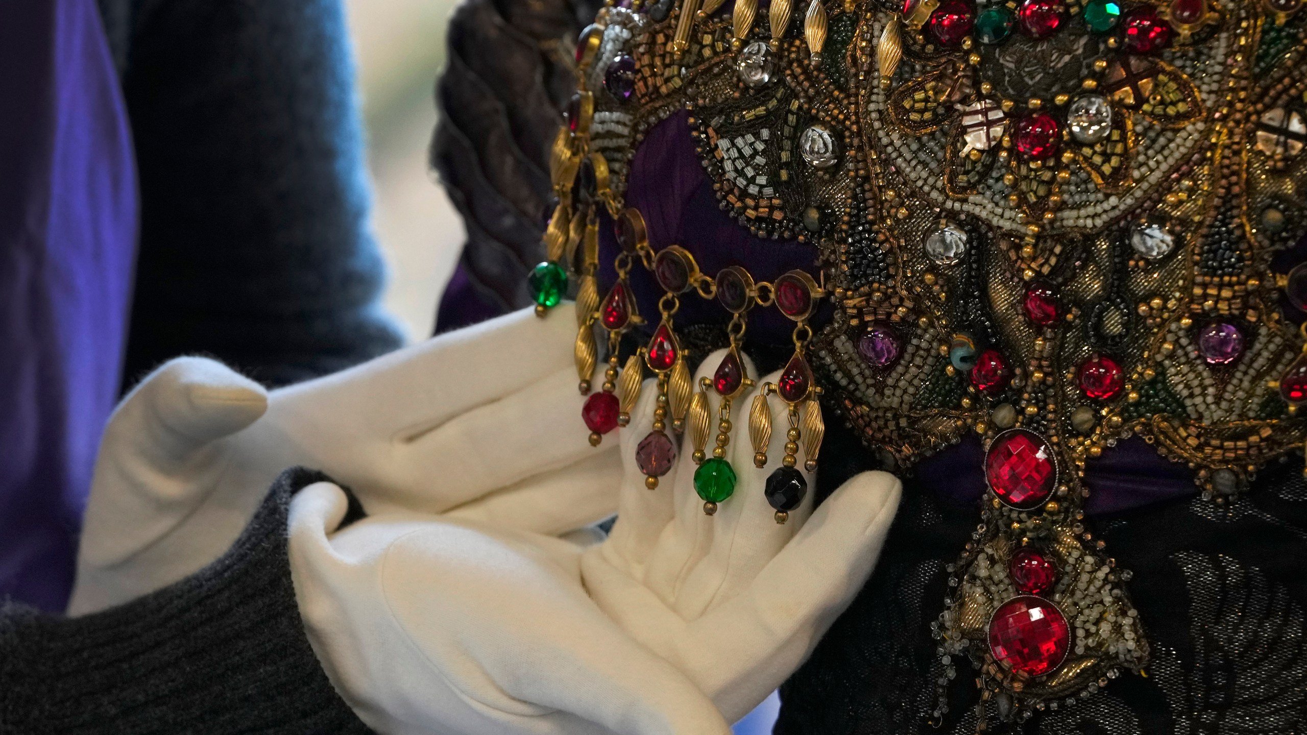 Detail on the bodice of Elizabeth Taylor's costume as Nadina Bullchoff in the film Young Toscanini, 1988 as it is displayed at Kerry Taylor Auctions in London, Tuesday, Feb. 27, 2024. The costume estimated at 3,000-5,000 UK Pounds (3,800-6,400 US Dollars) is one of 69 that will be for auction in the Lights Camera Auction event on March 5. The costumes have been donated by Cosprop in support of The Bright Foundation, an arts education charity, established and funded by John Bright, to provide life-enhancing, creative experiences for children and young people facing disadvantage. (AP Photo/Kirsty Wigglesworth)
