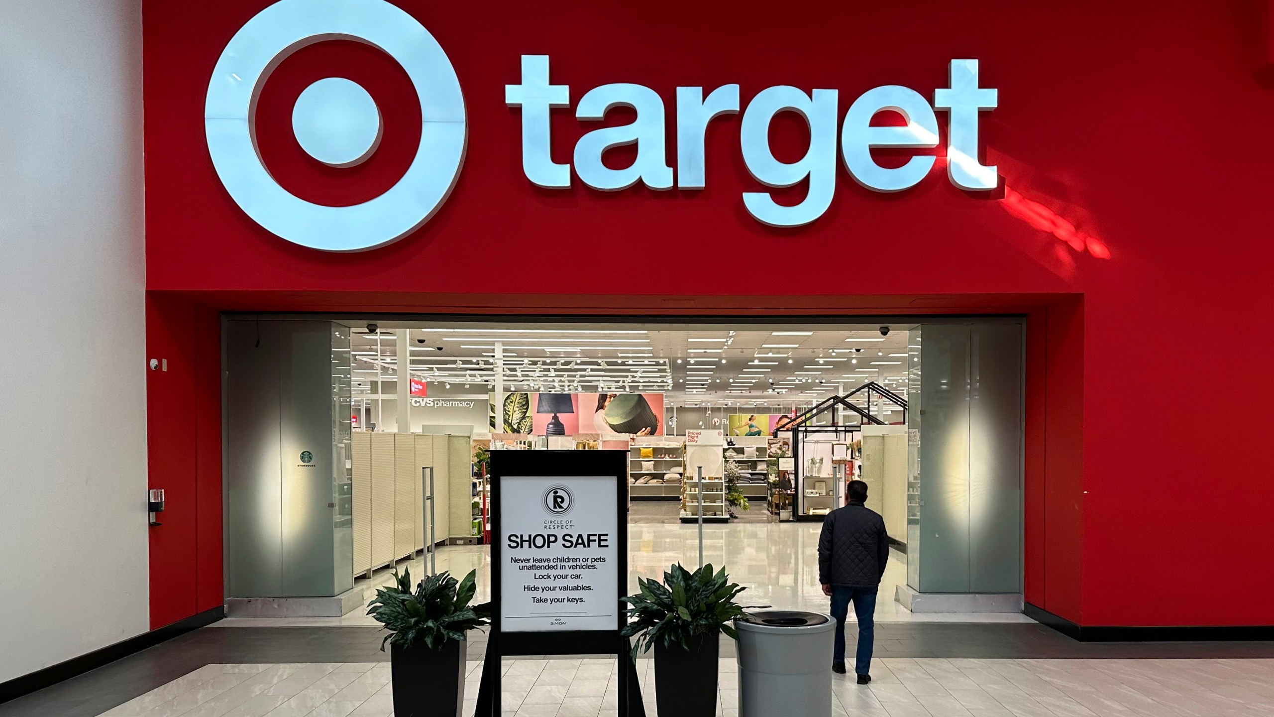 FILE - A person heads into a Target store Thursday, Jan. 11, 2024, in Lakewood, Colo. The company is slated to announce fourth-quarter financial results on Tuesday, March 5, 2024, hours before it holds its annual meeting with investors and analysts. The results and executive comments should offer more clues on shopper behavior in a still tough economic environment. (AP Photo/David Zalubowski, File)