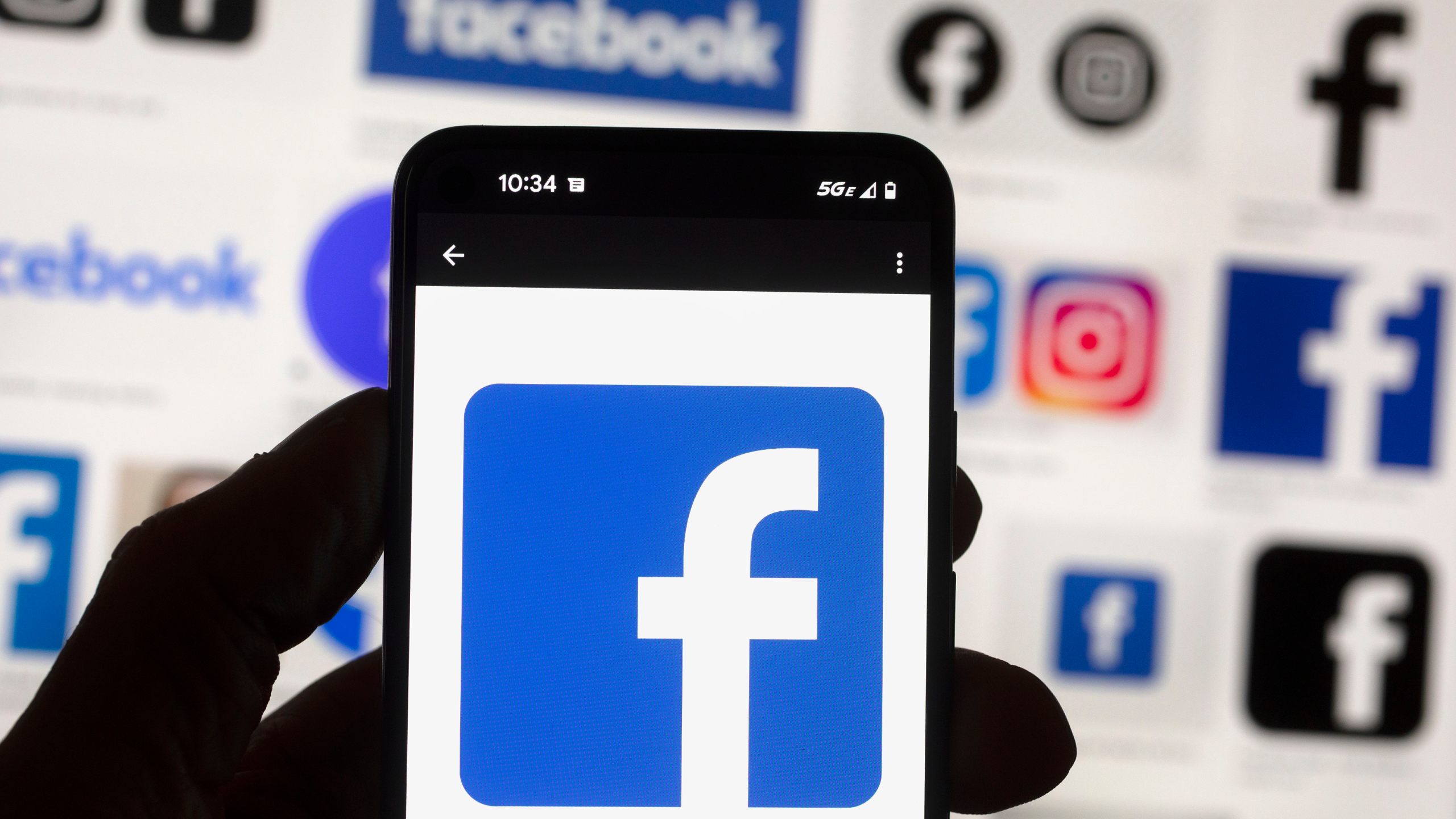 FILE - The Facebook logo is seen on a cell phone in Boston, USA, Oct. 14, 2022. Users of Meta's Facebook, Instagram, Threads and Messenger platforms are experiencing login issues in what appears to be a widespread outage. (AP Photo/Michael Dwyer, File)