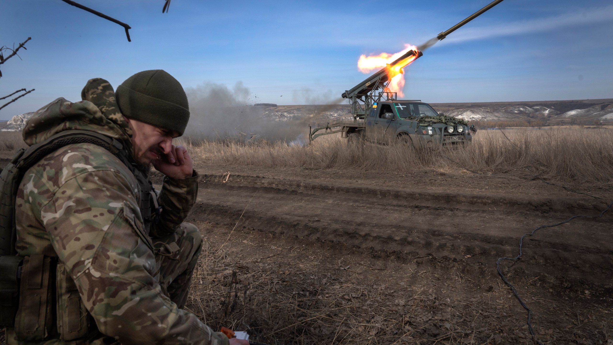 A Ukrainian officer from The 56th Separate Motorized Infantry Mariupol Brigade fires a multiple launch rocket system based on a pickup truck towards Russian positions at the front line, near Bakhmut, Donetsk region, Ukraine, Tuesday, March 5, 2024. (AP Photo/Efrem Lukatsky)