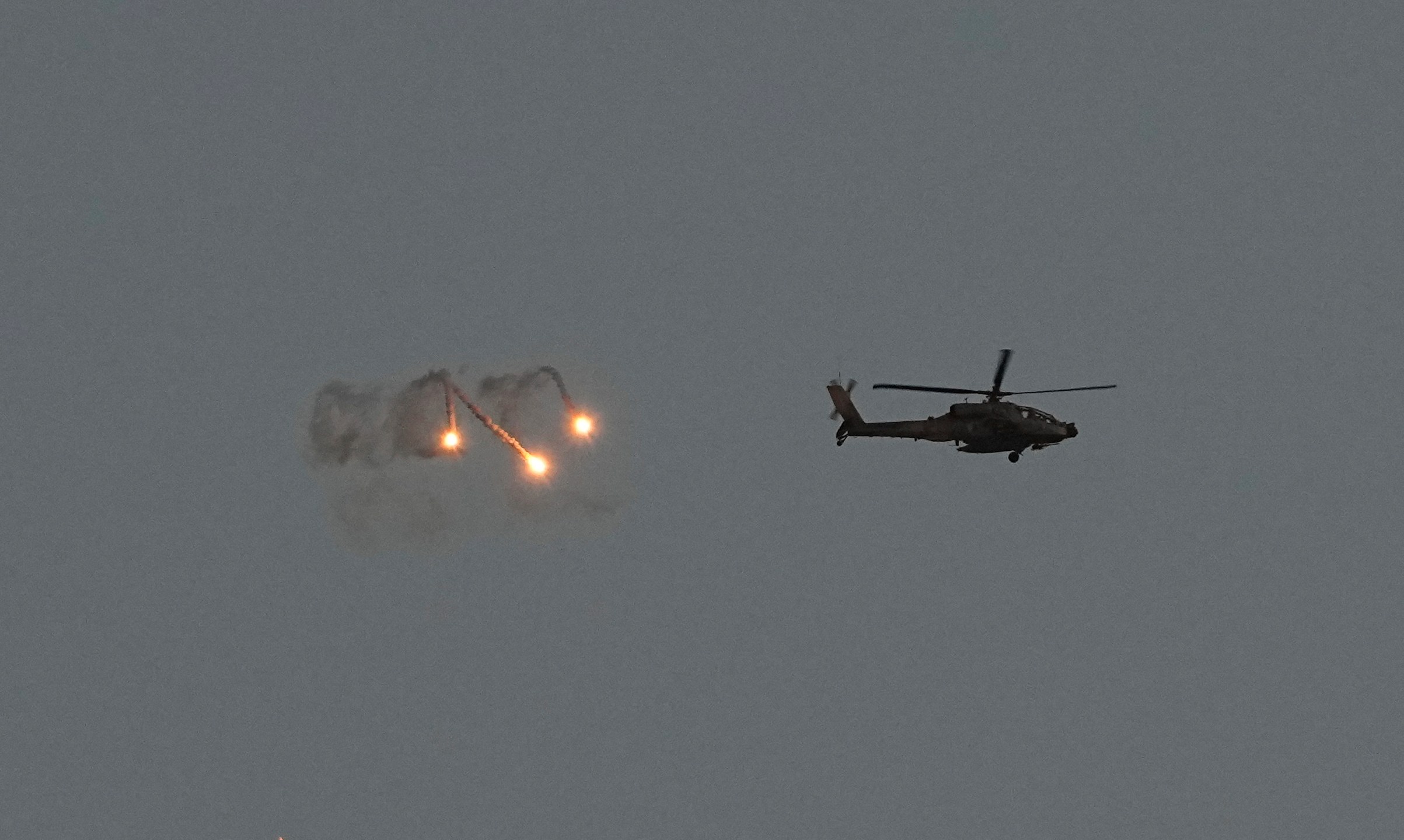 An Israeli Apache helicopter fires flares over the Gaza Strip as seen from southern Israel, Monday, March 4, 2024. The army is battling Palestinian militants across Gaza in the war ignited by Hamas' Oct. 7 attack into Israel. (AP Photo/Ohad Zwigenberg)