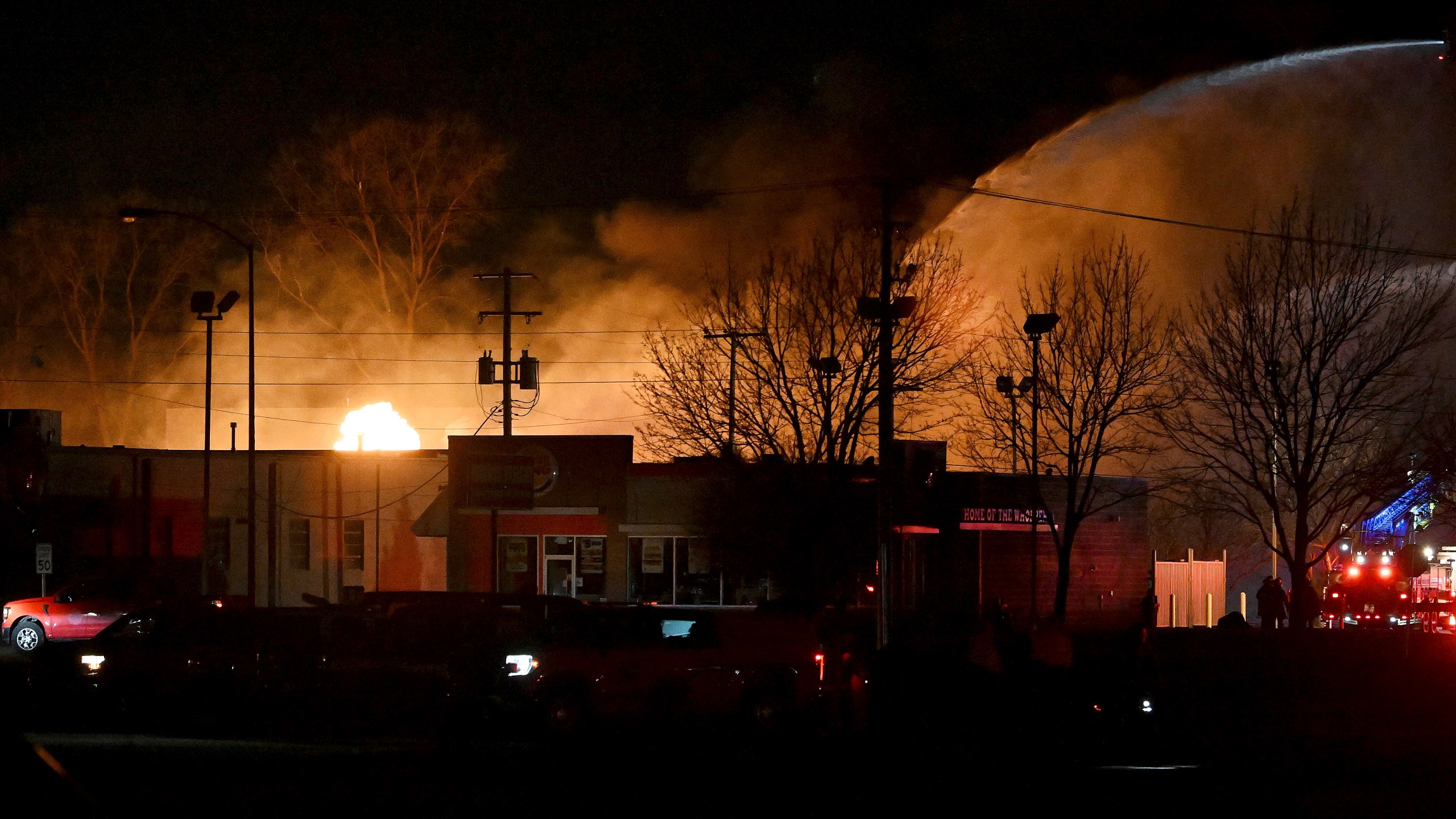 Fire departments battle an industrial fire near 15 Mile Road and Groesbeck Highway in the Detroit suburb of Clinton Township, on Monday, March 4, 2024. (Robin Buckson/Detroit News via AP)