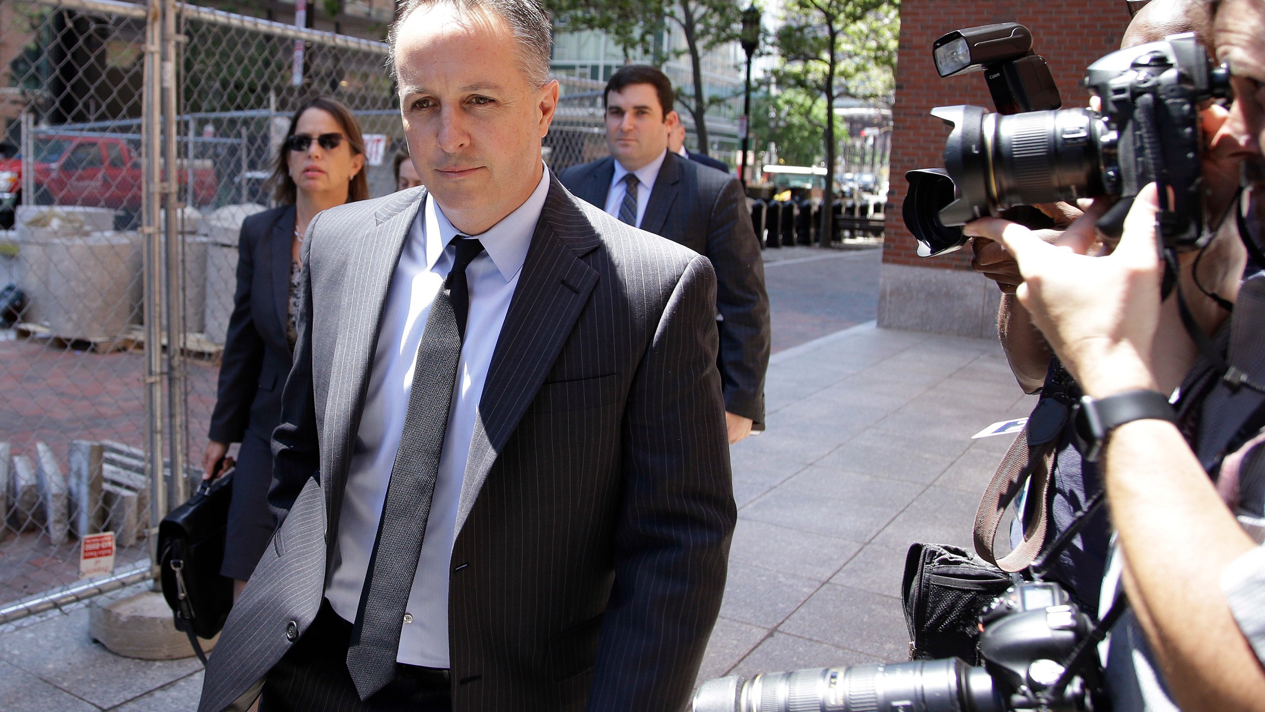 FILE - Barry Cadden, president of the New England Compounding Center, followed by members of his legal team, arrive at the federal courthouse for sentencing, June 26, 2017, in Boston. The co-founder of a specialty pharmacy that was at the center of a deadly national meningitis outbreak in 2012 pleaded no contest to involuntary manslaughter in Michigan, authorities said Tuesday, March 5, 2024. (AP Photo/Stephan Savoia, file)