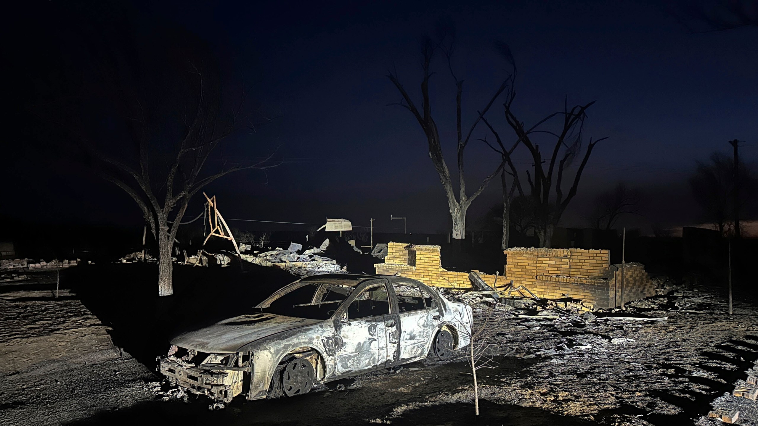 FILE - A charred vehicle sits near the ruins of a home after the property was burned by the Smokehouse Creek Fire, Wednesday, Feb. 28, 2024, in Fritch, Texas. Fritch Fire Chief Zeb Smith, whose small town was among the hardest hit last week by historic blazes sweeping across the Panhandle, died Tuesday, March 5, 2024, while fighting a structure fire, authorities said. (AP Photo/Ty O'Neil, File)