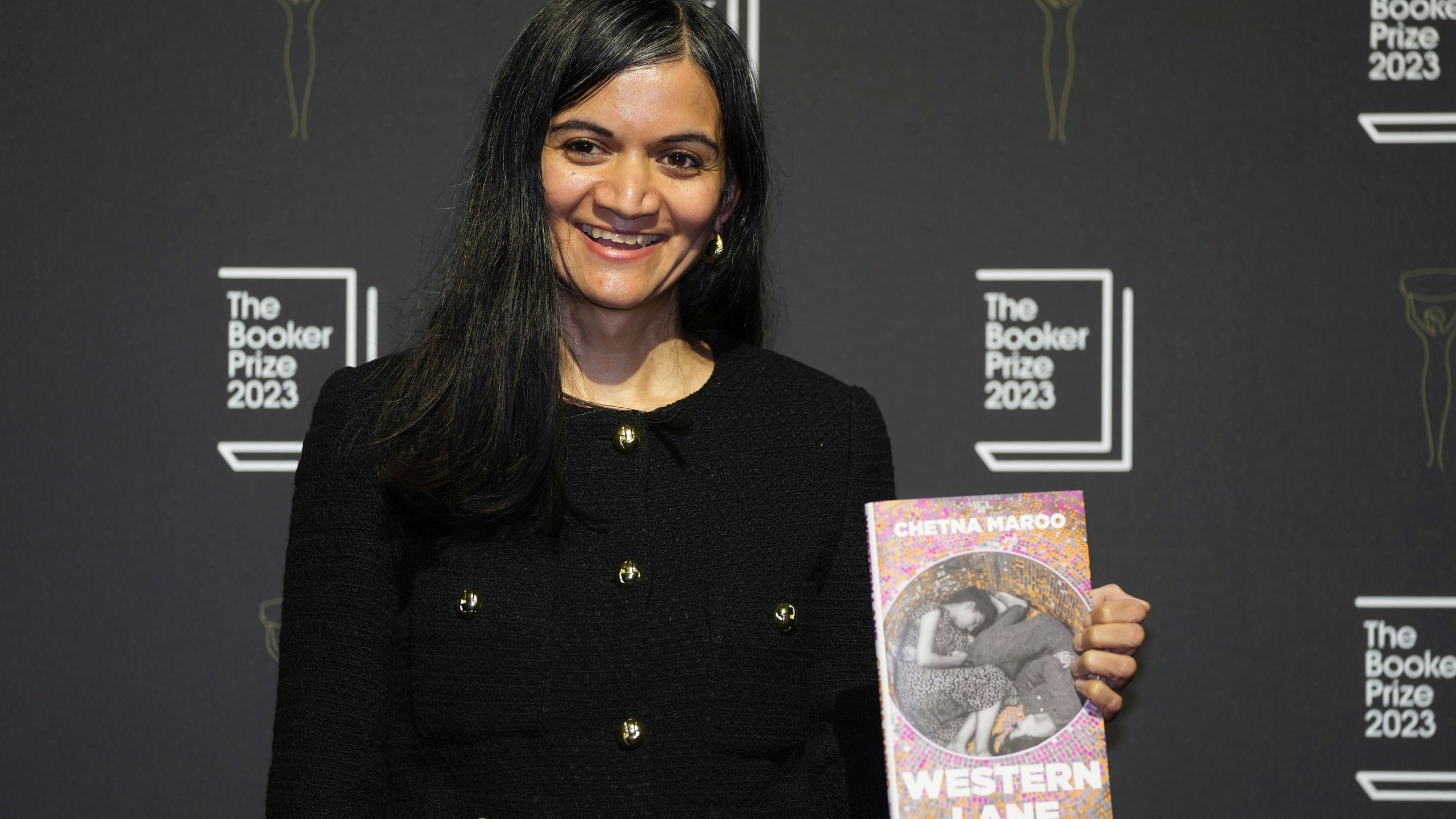 FILE - British author Chetna Maroo poses with her book "Western Lane" during a photocall with the six shortlisted authors for the Booker Prize 2023, in London, Thursday, Nov. 23, 2023 ahead of the award ceremony on Nov. 26 in London. Novels that give voice to the often unheard stories of migrants around the world are among the nominees for the 2024 Women’s Prize for Fiction on Tuesday, March 5, 2024. One of the debut novelists, British author Chetna Maroo, was a finalist for the 2023 Booker Prize with “Western Lane,” the story of a squash prodigy grappling with family tragedy. (AP Photo/Kin Cheung, File)