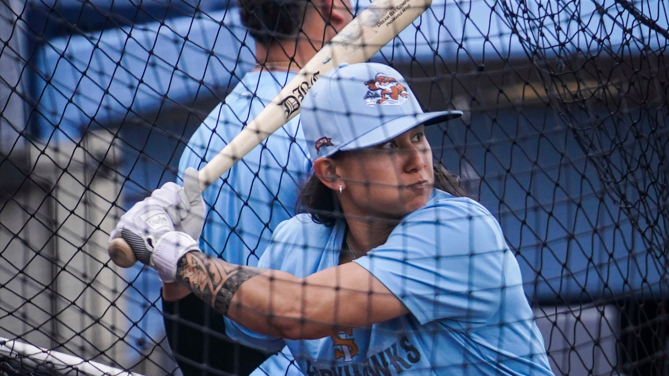 FILE -Kelsie Whitmore, a 23-year-old two-way player for the Atlantic League's Staten Island FerryHawks, warmup in the batting cage, Friday, May 13, 2022, in New York. MLB The Show 24 has unveiled Whitmore, a female player mode for this year's video game. A trailer released Tuesday, March 5, 2024 showcases “Road to the Show: Women Pave Their Way” for the game scheduled to be released March 19. (AP Photo/Bebeto Matthews, File)