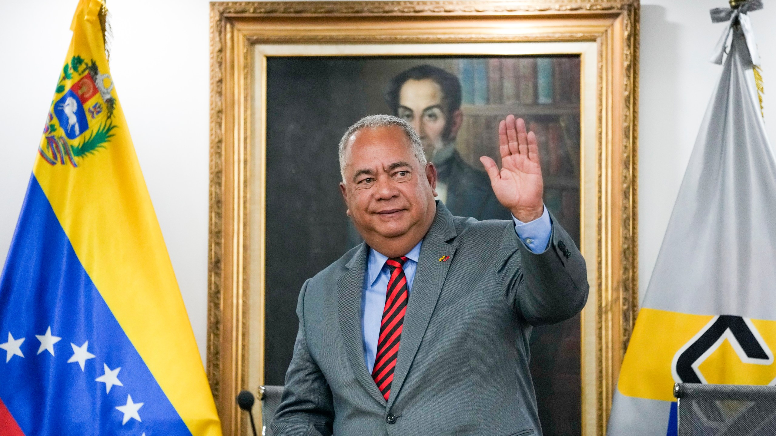 National Electoral Council (CNE) President Elvis Hidrobo Amoroso waves to the press at the National Electoral Council headquarters in Caracas, Venezuela, Tuesday, March 5, 2024. Amoroso announced that Venezuela's presidential election will take place on July 28. (AP Photo/Ariana Cubillos)