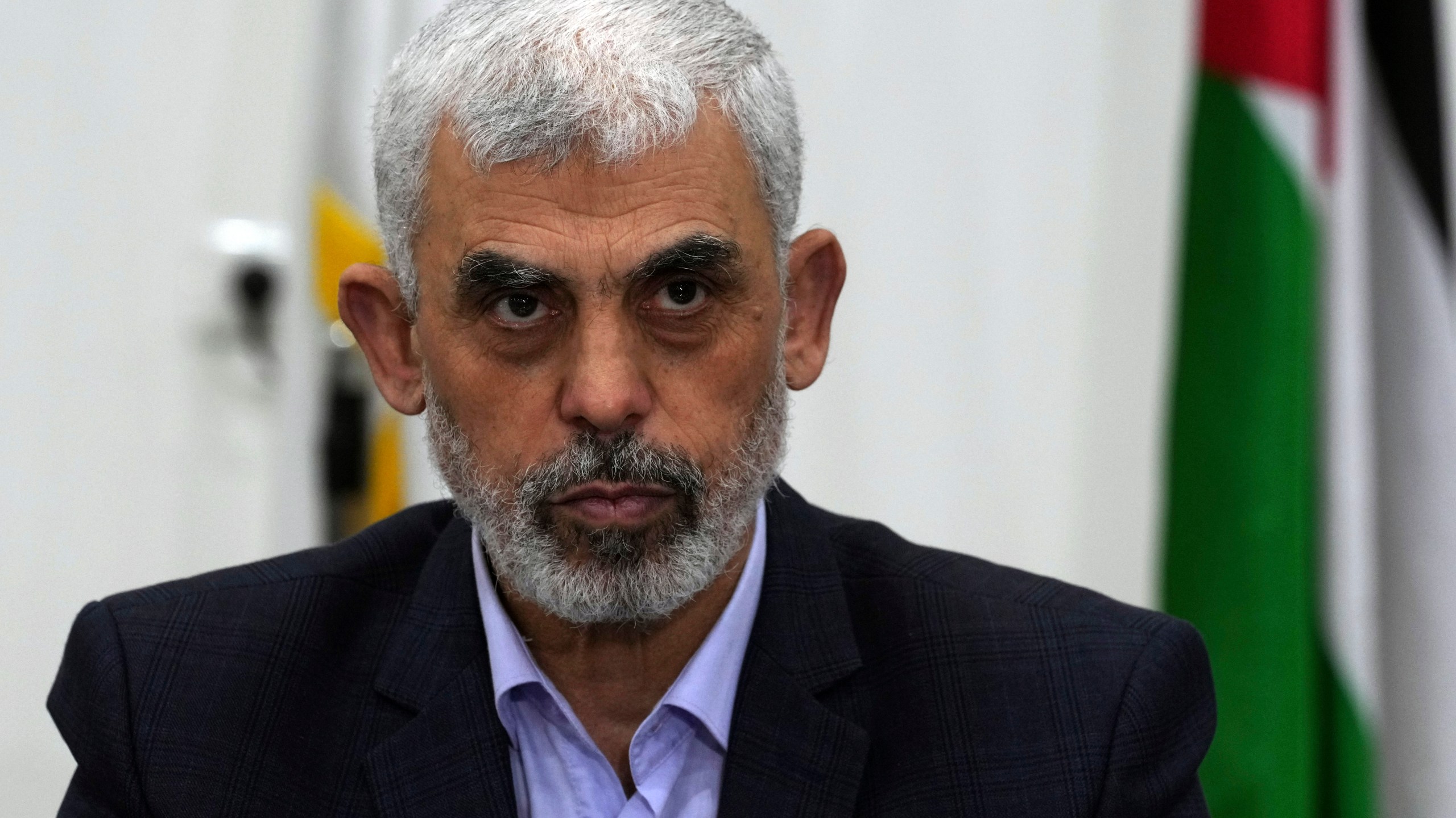 FILE - Yehya Sinwar, head of Hamas in Gaza, chairs a meeting with leaders of Palestinian factions at his office in Gaza City, Wednesday, April 13, 2022. Israel can either try to annihilate Hamas, which would mean almost certain death for the estimated 100 hostages still held in Gaza, or it can cut a deal that would allow the militants to claim a historic victory. Either outcome would be excruciating for Israelis. And either might be seen as acceptable by Hamas, which valorizes martyrdom. (AP Photo/Adel Hana, File)