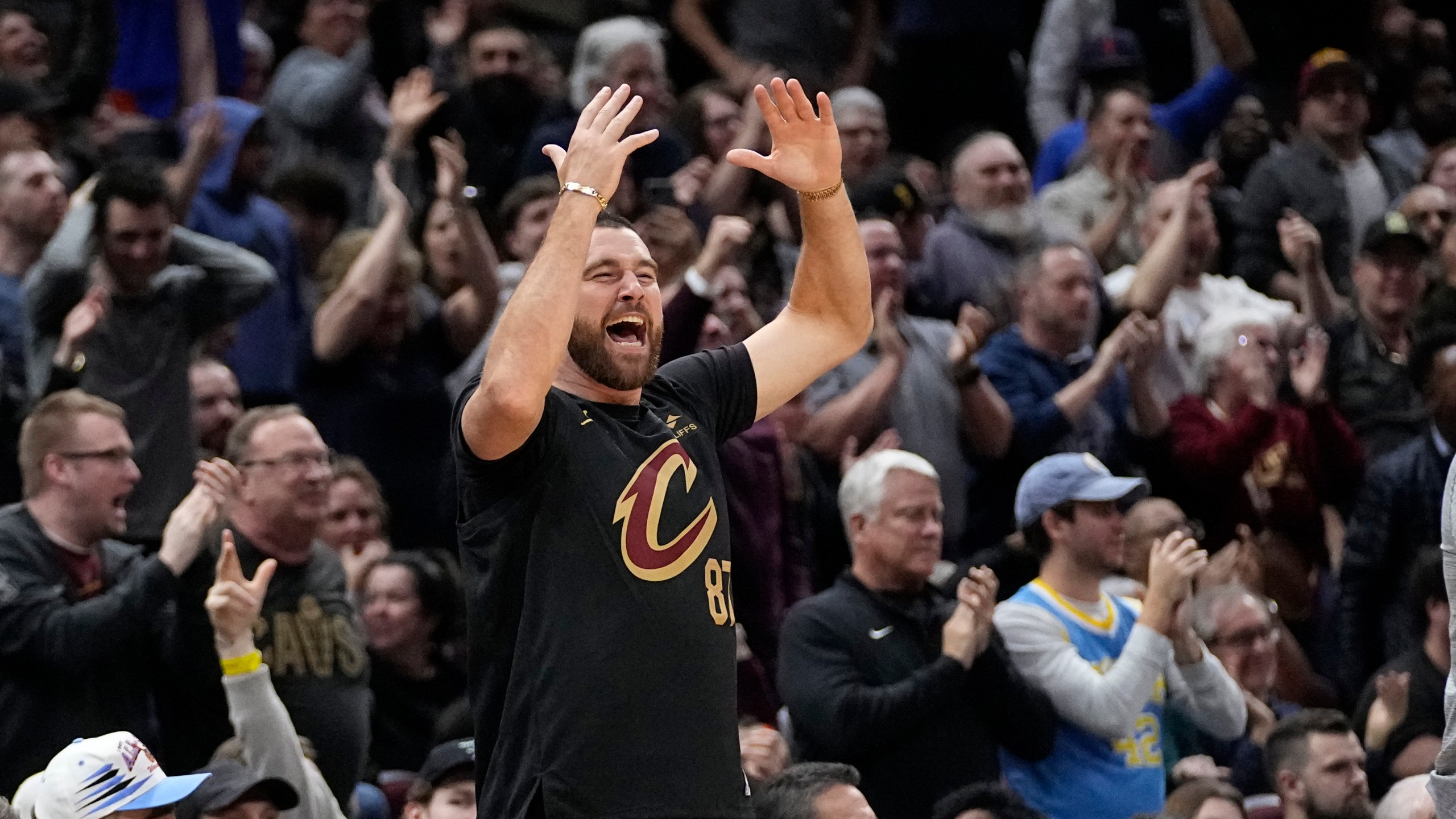 Travis Kelce cheers from courtside in the second half of an NBA basketball game between the Boston Celtics and the Cleveland Cavaliers, Tuesday, March 5, 2024, in Cleveland. (AP Photo/Sue Ogrocki)
