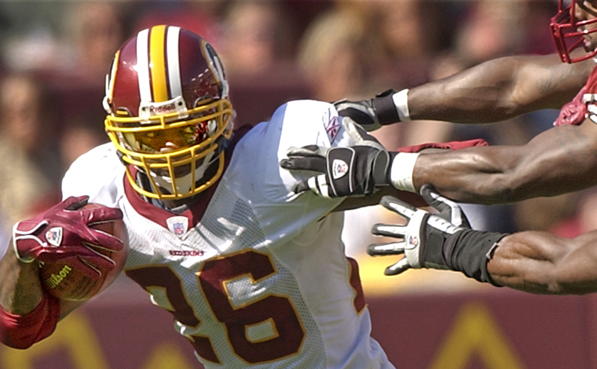FILE - Washington Redskins' Clinton Portis tries to turn the corner on San Francisco 49ers defenders on Oct. 23, 2005, in Landover, Md., Oct. 23, 2005. A rare star for star trade was made in 2004, when Washington dealt four-time Pro Bowl cornerback Champ Bailey to Denver for Clinton Portis. (Bruce Parker/Richmond Times-Dispatch via AP, File)