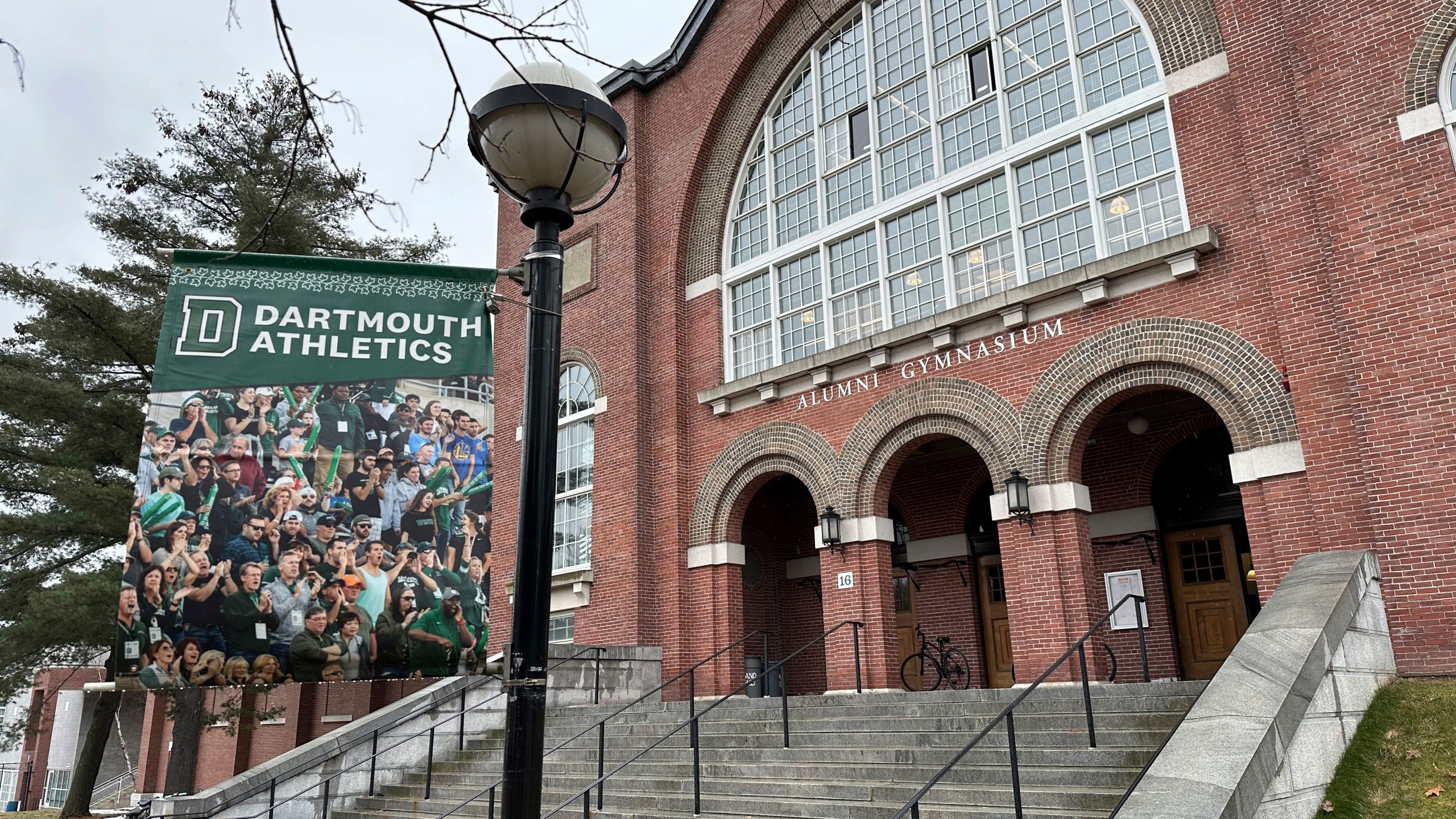 A Dartmouth Athletics banner hangs outside Alumni Gymnasium on the Dartmouth University campus in Hanover, N.H., Tuesday, March 5, 2024. Dartmouth basketball players vote Tuesday on whether to form a union. (AP Photo/Jimmy Golen)