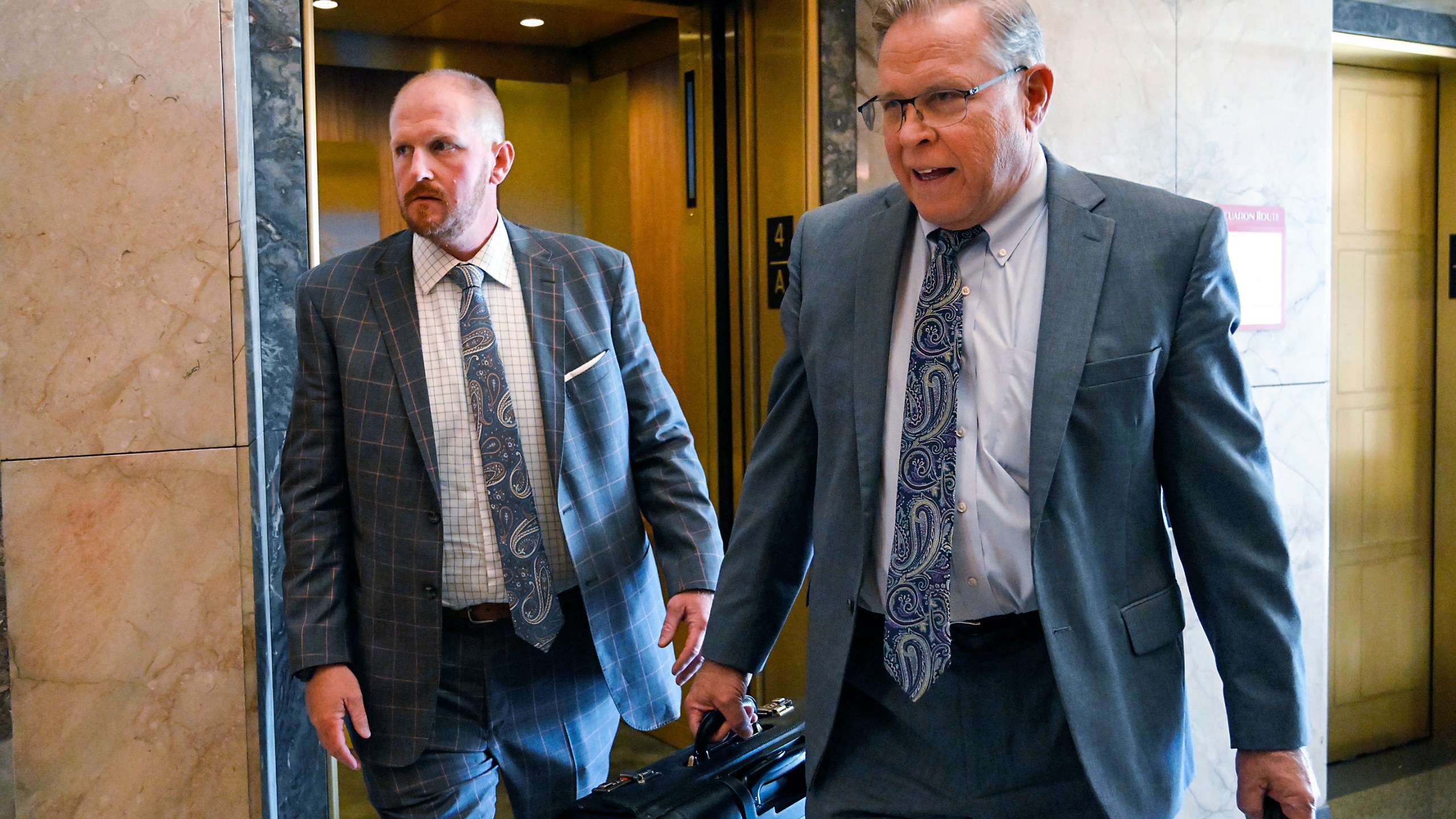FILE - Britt Reid, left, walks to a courtroom with his attorney J.R. Hobbs, right, Tuesday, Nov. 1, 2022, at the Jackson County Courthouse, in Kansas City, Mo. Facing a flurry of outrage over the decision to shorten the prison sentence of former Kansas City Chiefs assistant coach Britt Reid, Missouri Gov. Mike Parson offered “deepest sympathy” to the family of a 5-year-old girl who was seriously injured in a drunken driving crash. But Parson stopped short of apologizing in a statement Tuesday, March 5, 2024, to The Kansas City Star for his decision last week to commute the remainder of Reid’s three-year prison sentence to house arrest, subject to several conditions. (Tammy Ljungblad/The Kansas City Star via AP, File)