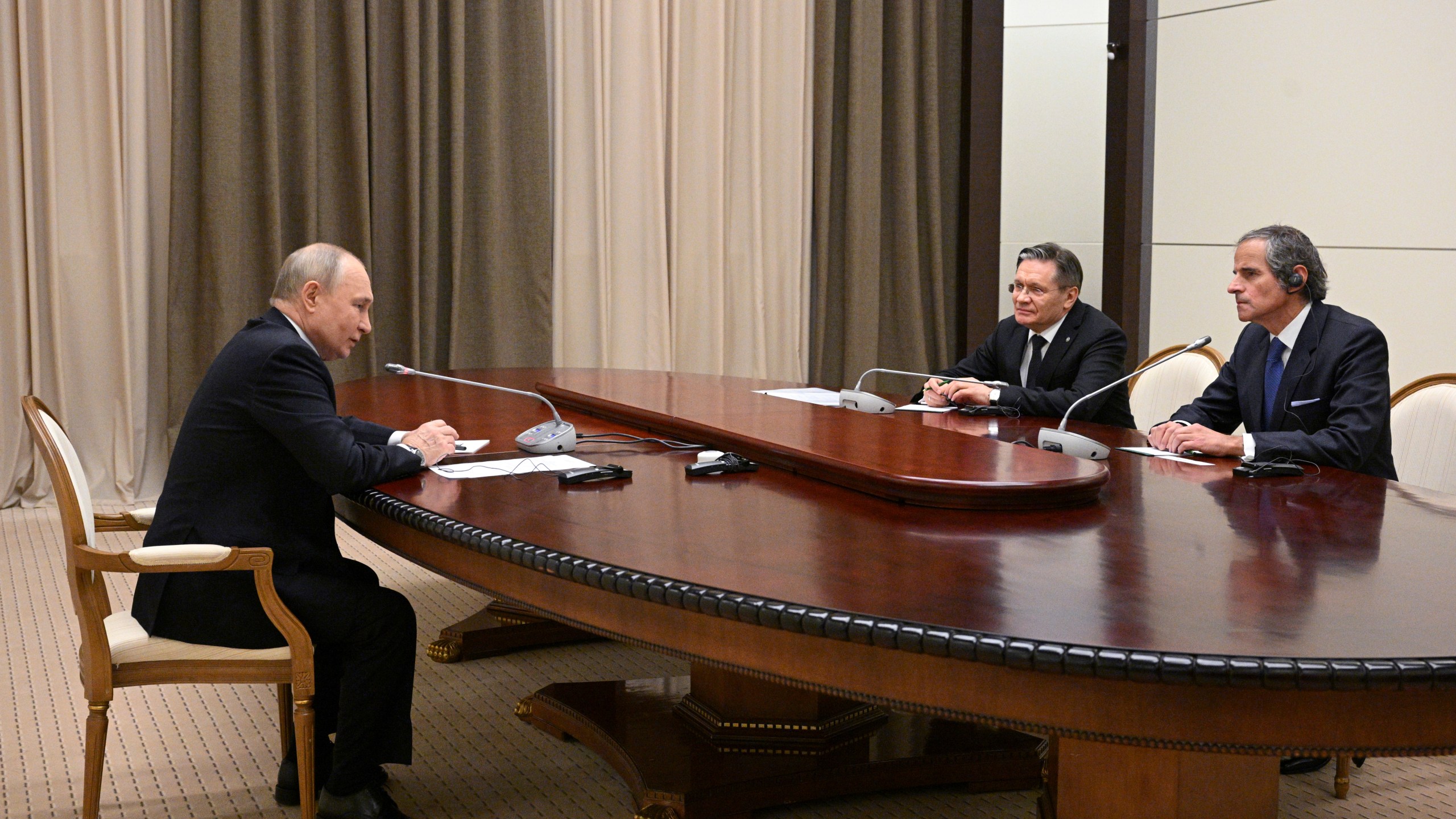 Russian President Vladimir Putin, left, Rosatom State Atomic Energy Corporation Director General Alexey Likhachev, centre, and International Atomic Energy Agency (IAEA) Director General Rafael Mariano Grossi, right, attend a meeting in Sochi, Russia, Wednesday, March 6, 2024. (Ramil Sitdikov, Sputnik, Kremlin Pool Photo via AP)