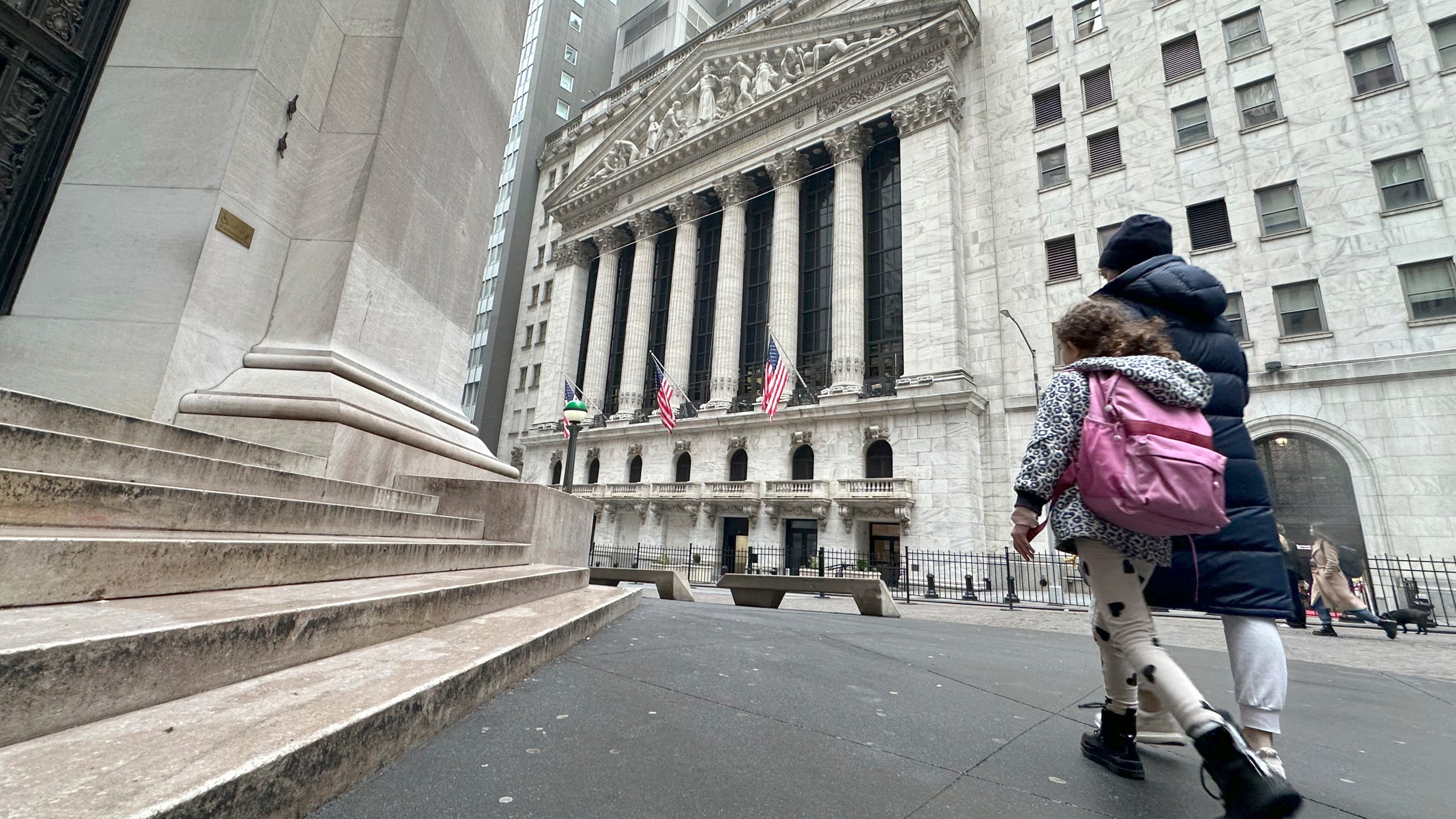People pass the New York Stock Exchange on Wednesday, March 6, 2024, in New York. World shares are mostly higher after tumbling Big Tech stocks dragged Wall Street to its worst day in three weeks. (AP Photo/Peter Morgan)