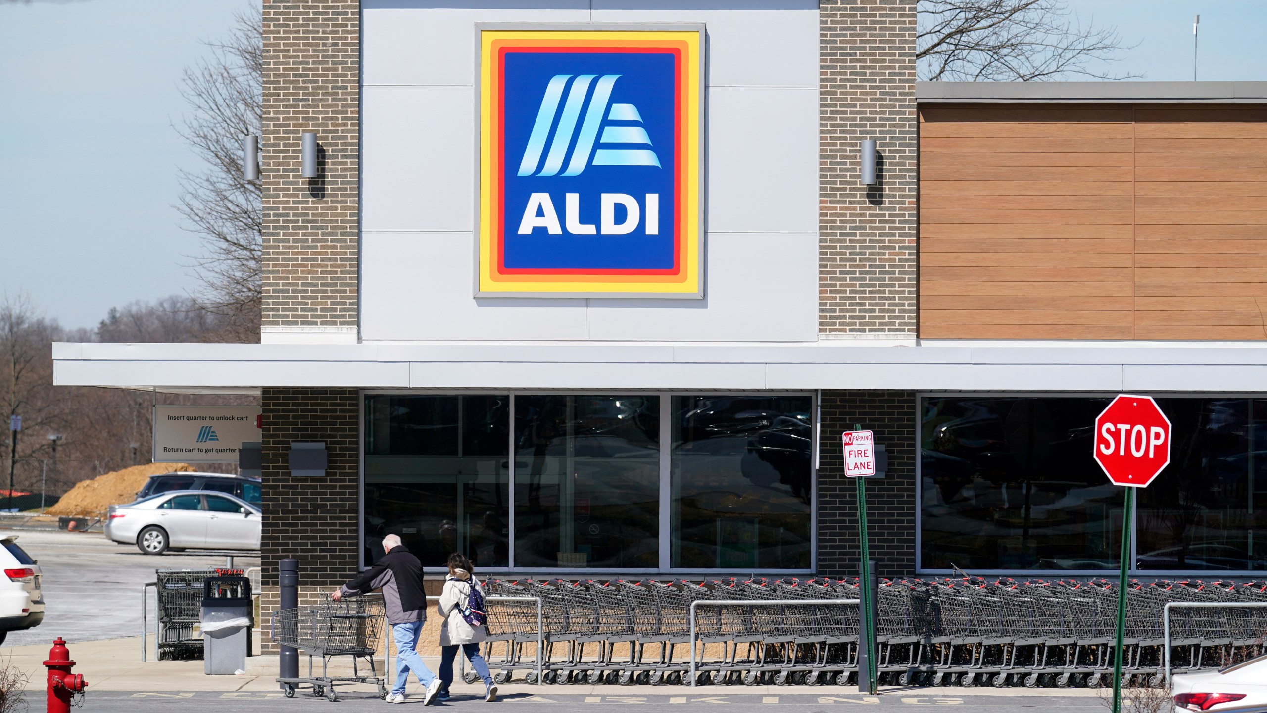 FILE - Customers walk into an Aldi supermarket in Bensalem, Pa., March 14, 2022. Discount grocer Aldi plans to add 800 stores across the U.S. in a five-year expansion plan as it looks to capitalize on cost-conscious Americans feeling the pinch at grocery stores. (AP Photo/Matt Rourke, File)