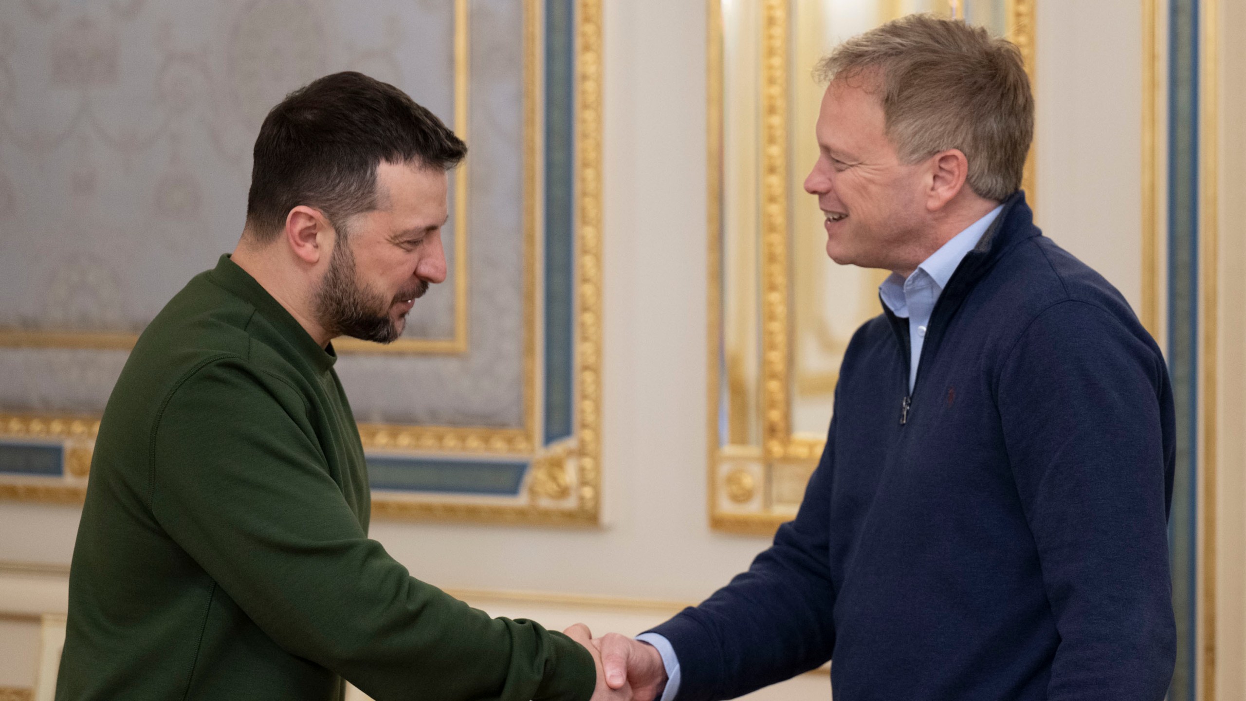 In this photo provided by the Ukrainian Presidential Press Office, Ukrainian President Volodymyr Zelenskyy, left, and Britain's Defence Secretary Grant Shapps shake hands during their meeting in Kyiv, Ukraine, Thursday, March 7, 2024. Britain said Thursday that it would provide 10,000 drones to arm Ukraine in its fight against Russia. (Ukrainian Presidential Press Office via AP)